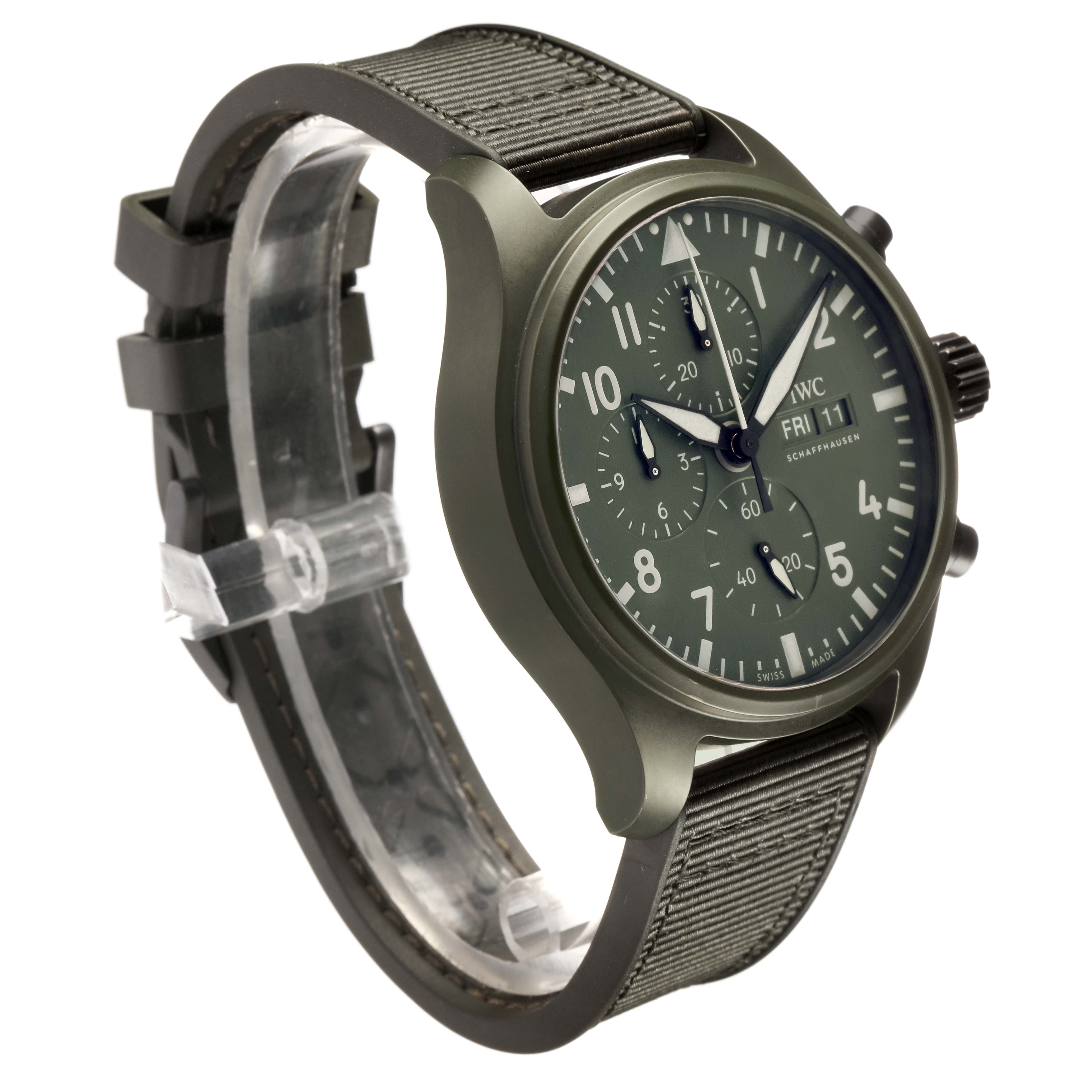 The IWC Pilot IW389106 Men's Ceramic Green Dial model watch is shown at a three-quarter angle, displaying the face, case, and fabric strap.