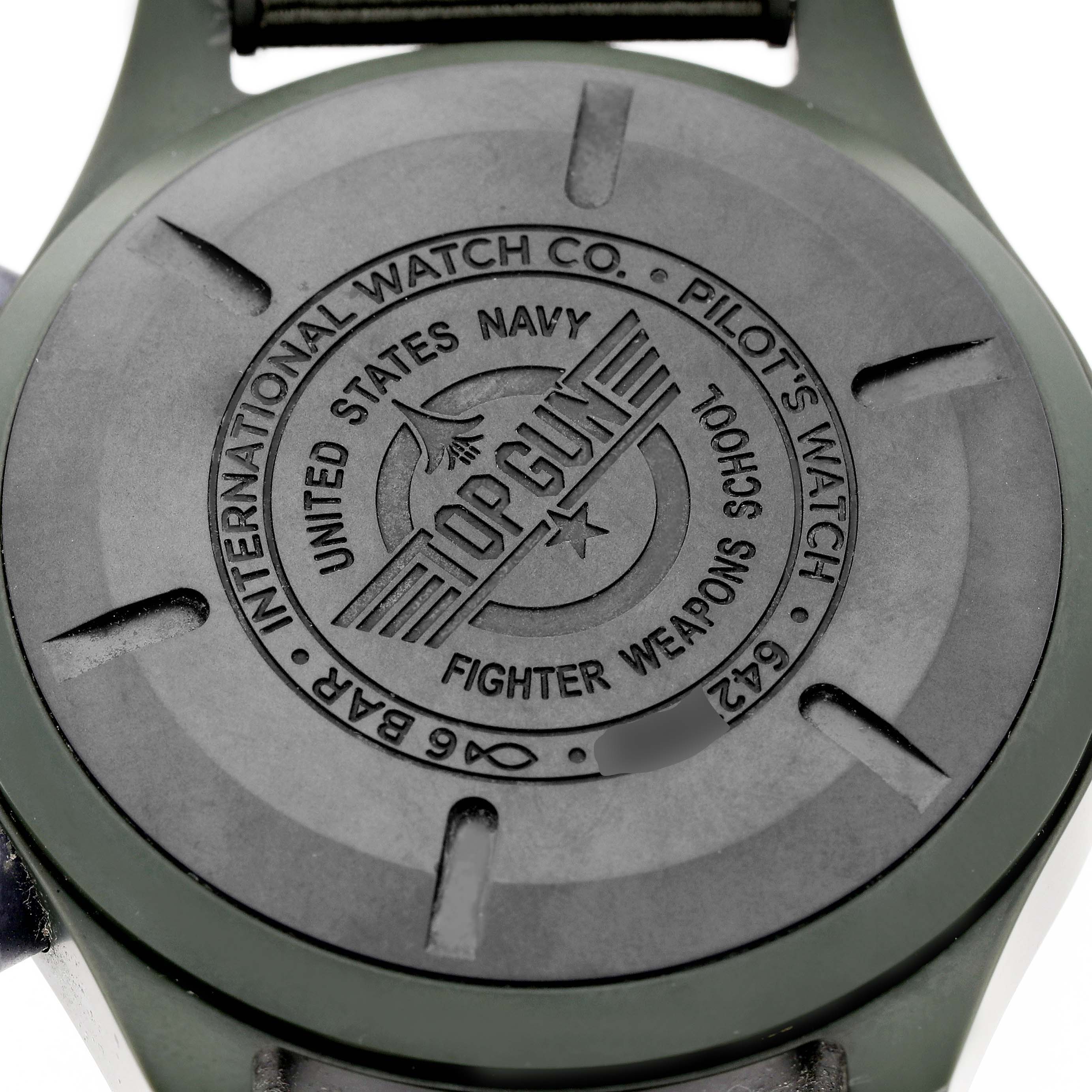 The image shows the case back of the IWC Pilot IW389106 Men's Ceramic Green Dial model watch, featuring "Top Gun" and related engravings.