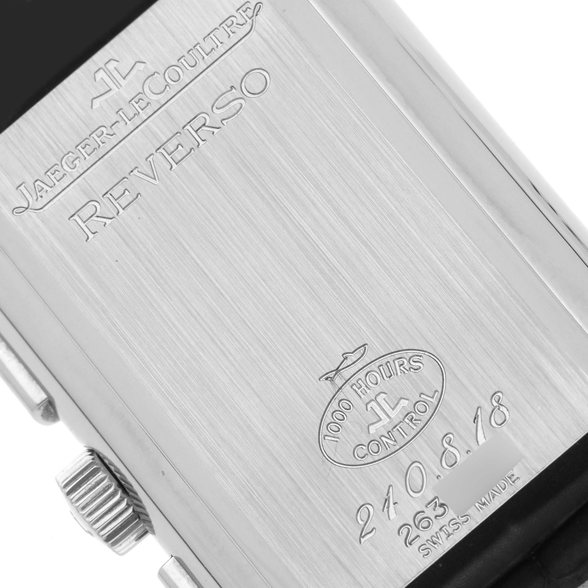 This is an angled view of the back of a Jaeger-LeCoultre Reverso watch, showing the engraving and crown.