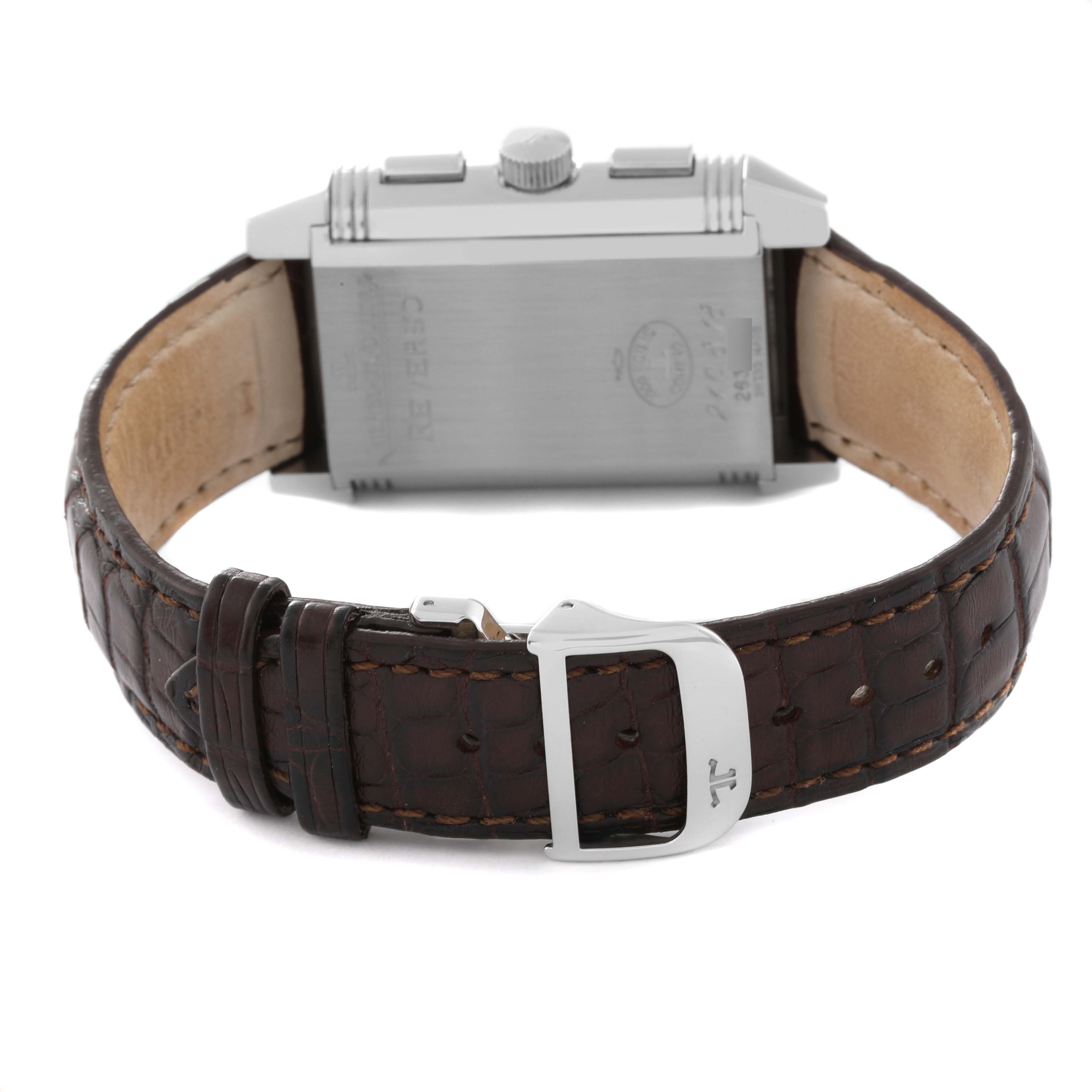 The image shows the back of a Jaeger-LeCoultre Reverso watch, highlighting its leather strap, buckle, and caseback.