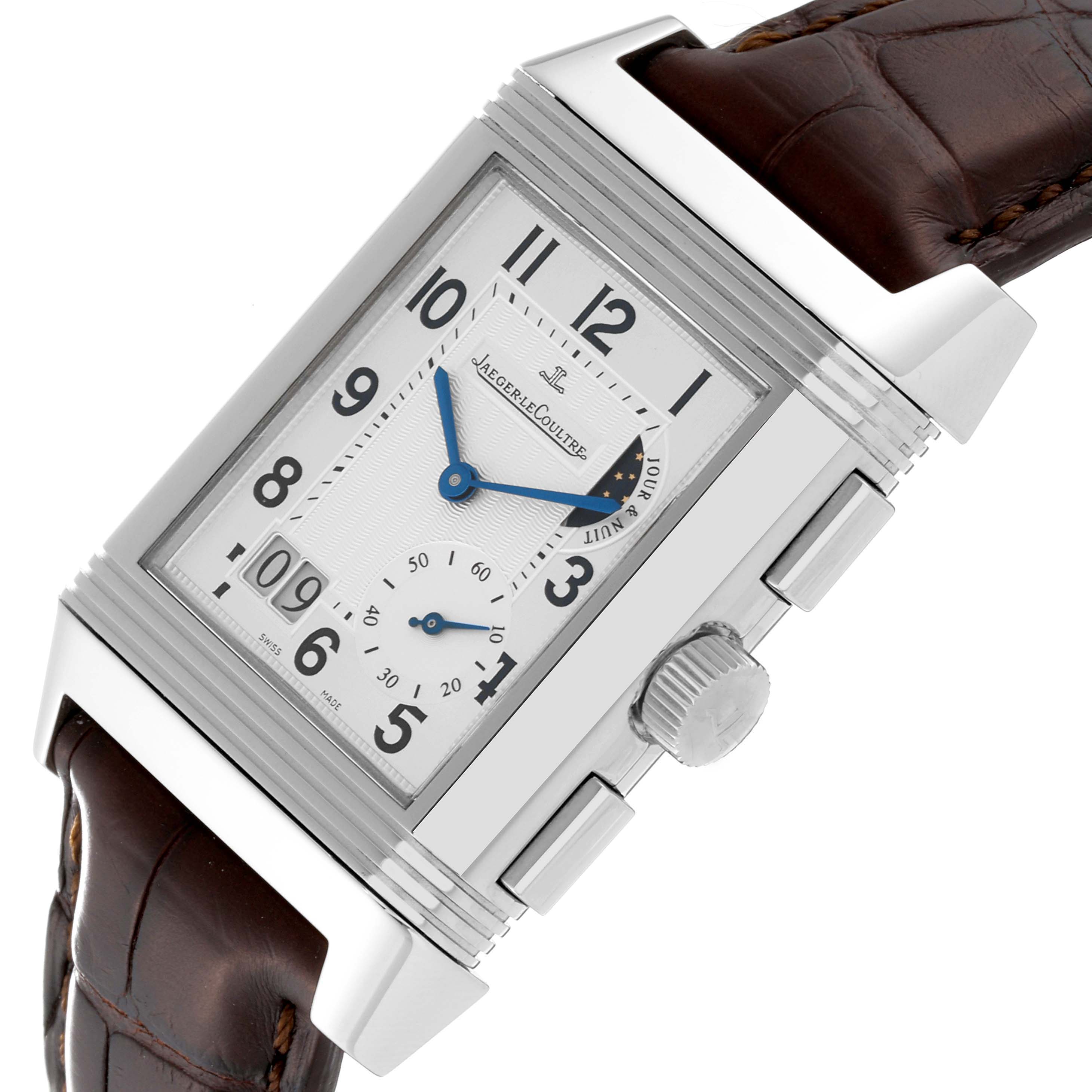 The image shows a Jaeger-LeCoultre Reverso watch at an angle, highlighting its face, crown, and part of the brown leather strap.