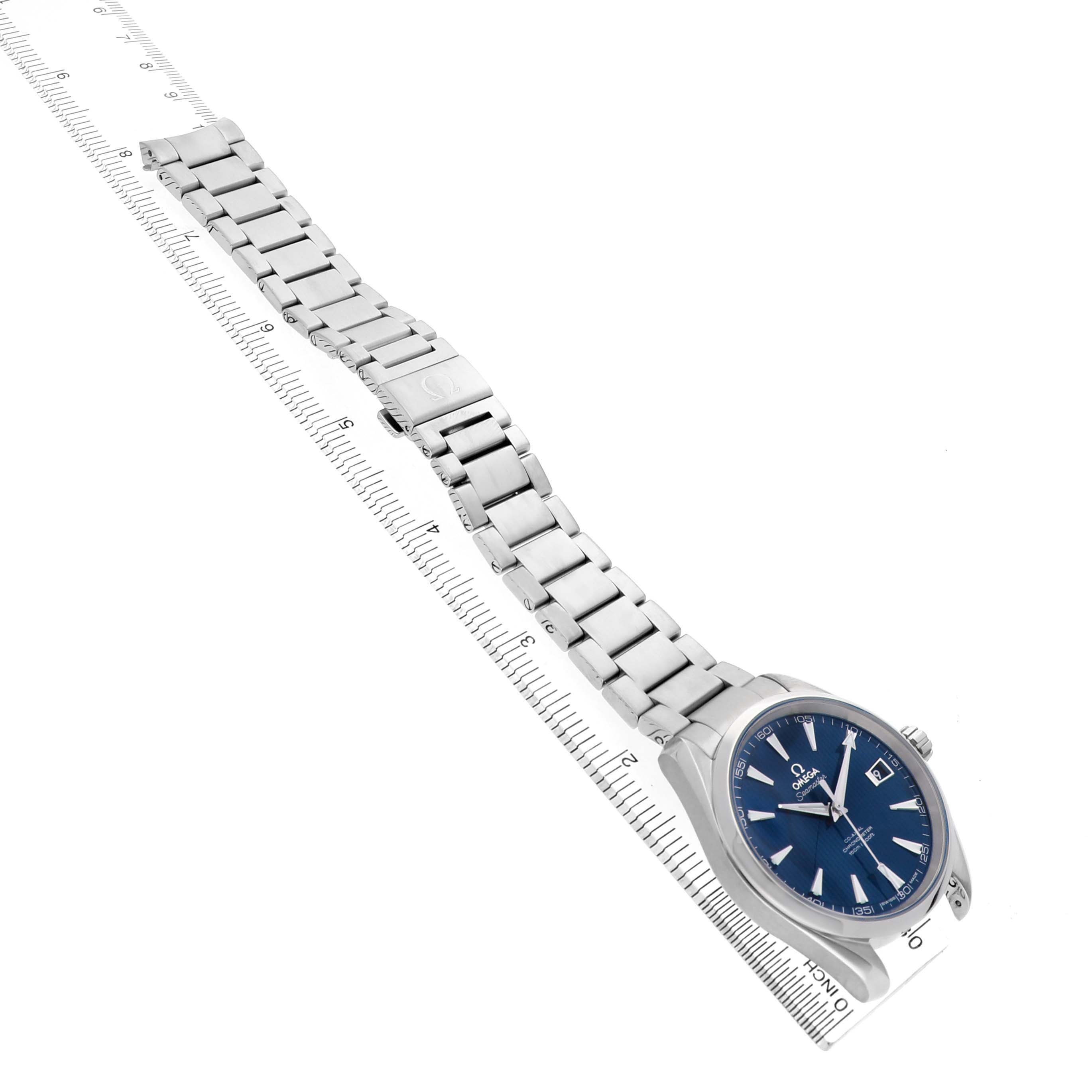 The Omega Aqua Terra 231.10.42.21.03.001 Men's Stainless Steel Blue Dial watch is shown from a top-down angle, displaying the full bracelet and watch face with a ruler for scale.