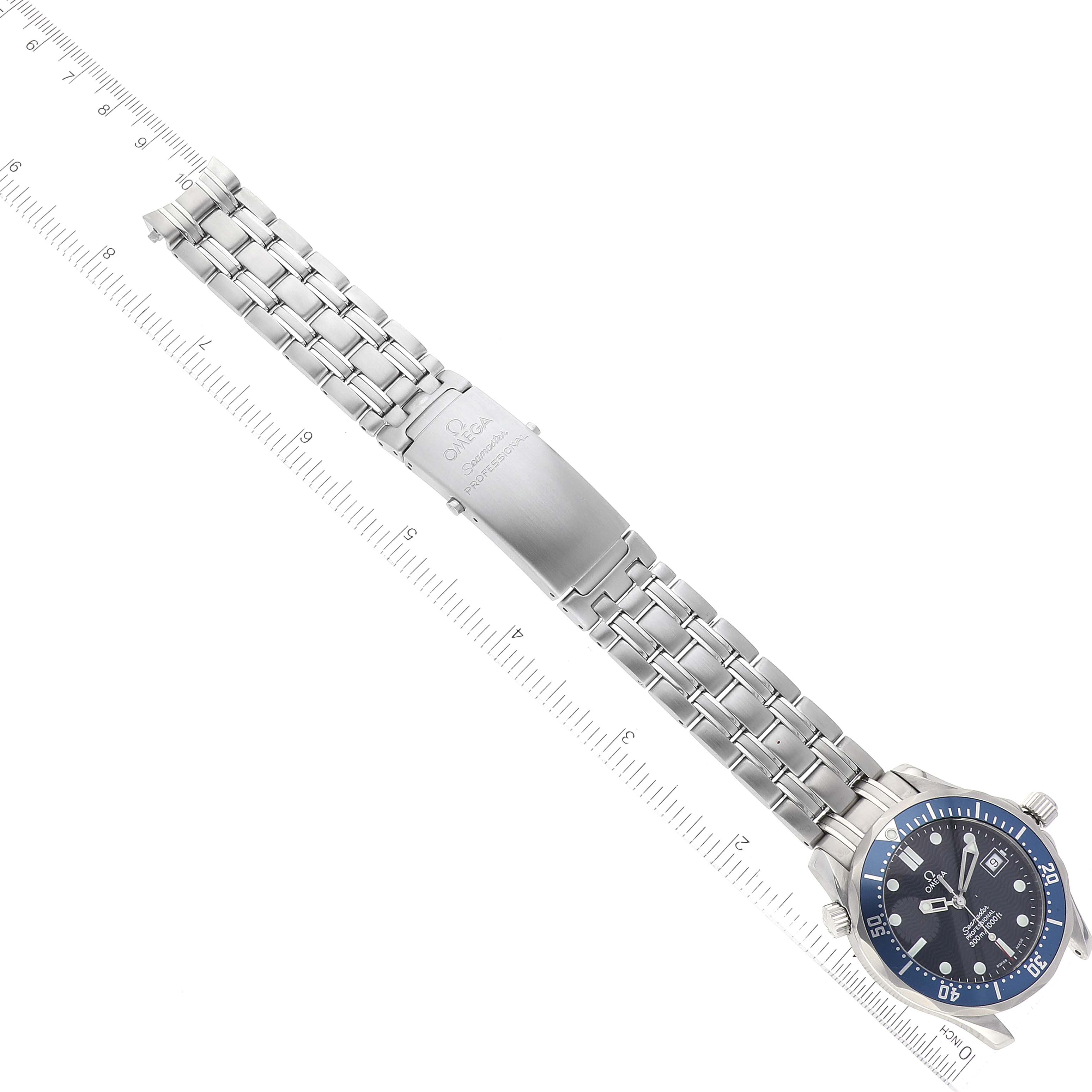 The image shows an Omega Seamaster 2561.80.00 Men's Stainless Steel Blue Dial 2561.80.00 Men's Stainless Steel Blue Dial watch laid flat with a ruler beside it, displaying the dial, bracelet, and clasp.
