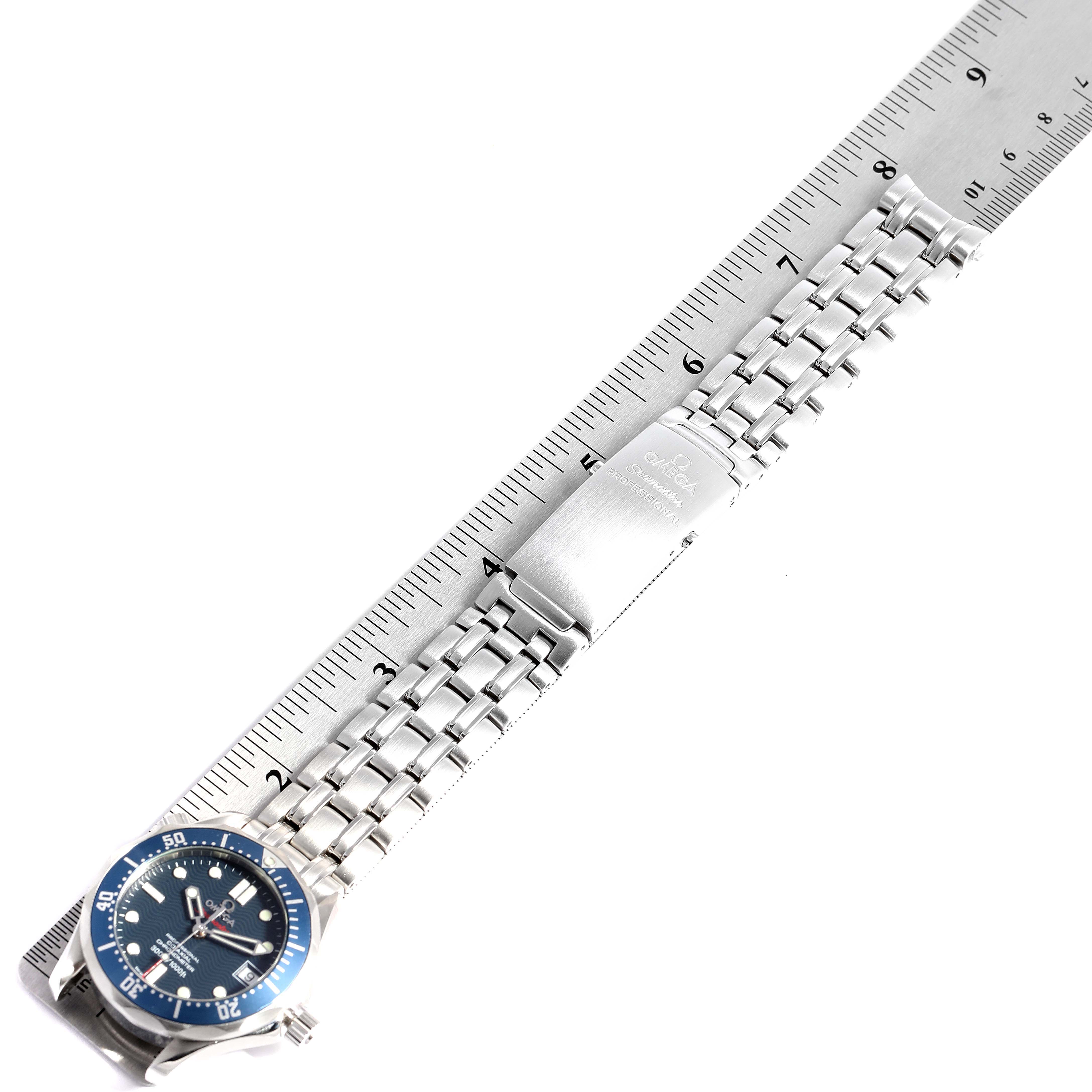 The image shows an Omega Seamaster 2222.80.00 Men
s Stainless Steel Blue Dial 2222.80.00 Men
s Stainless Steel Blue Dial watch with a blue dial and stainless steel bracelet, lying flat alongside a ruler.