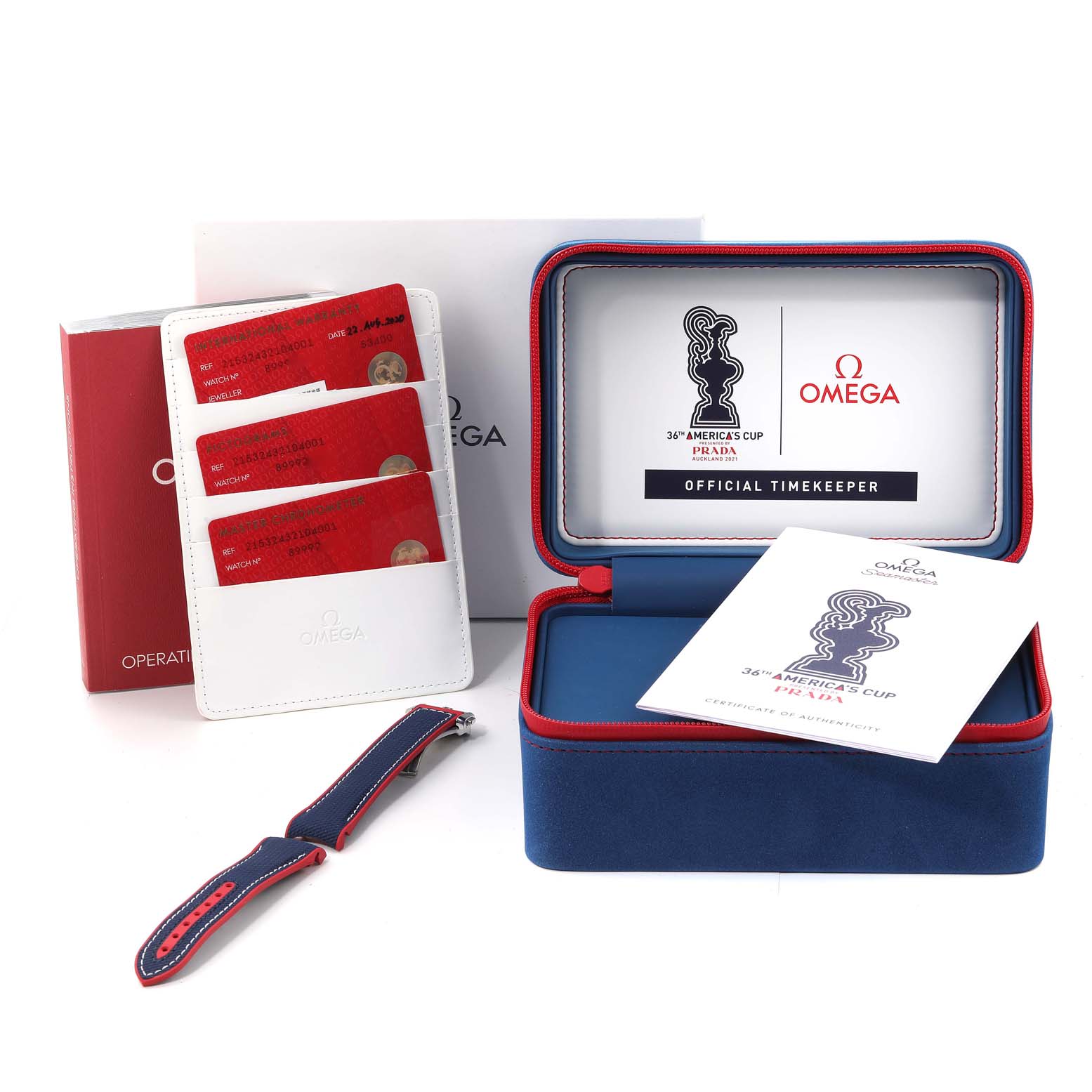 The image shows the Omega Planet Ocean 215.32.43.21.04.001 Men's Stainless Steel White Dial 215.32.43.21.04.001 Men's Stainless Steel White Dial model's presentation box, warranty cards, an instruction booklet, and an additional strap.