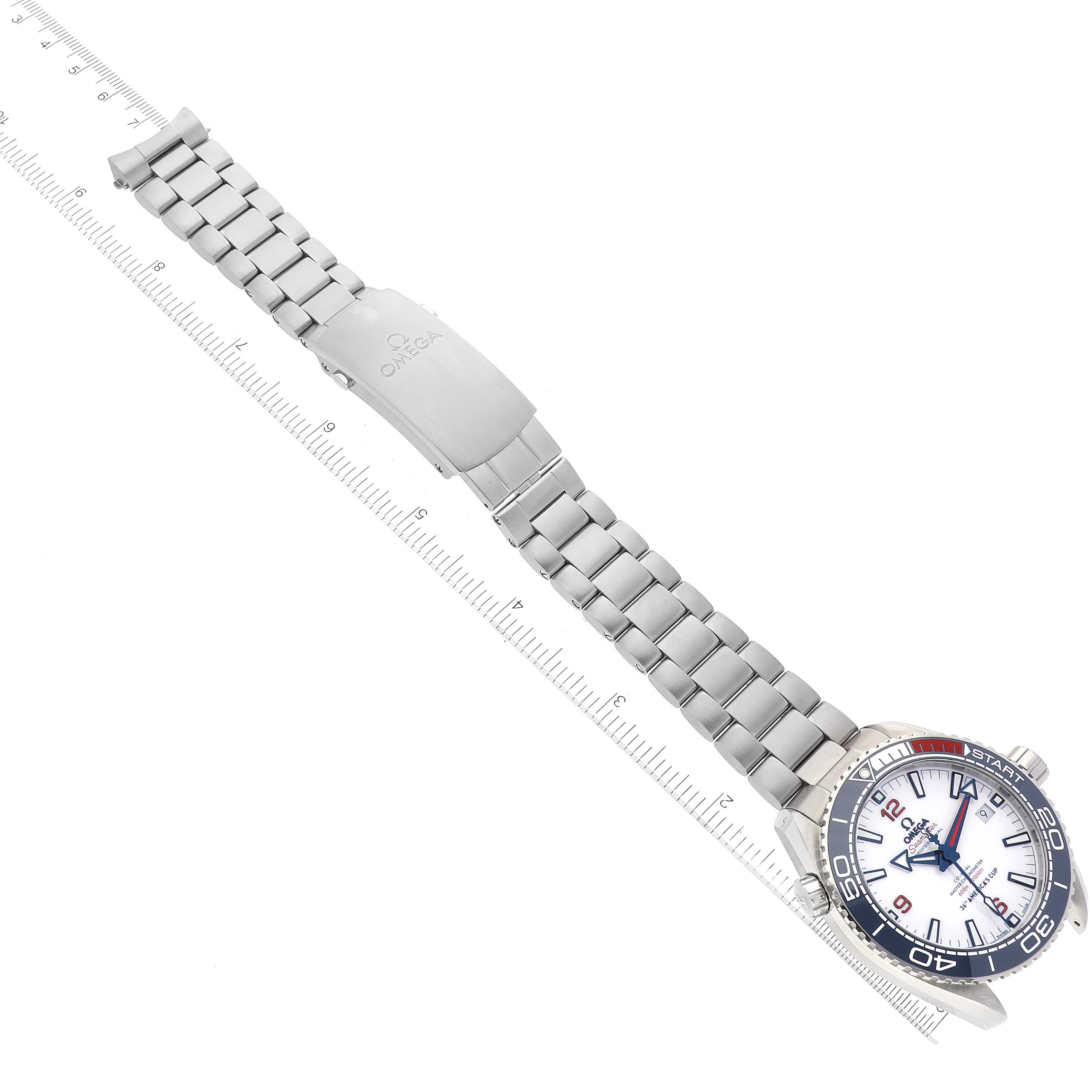 The Omega Planet Ocean 215.32.43.21.04.001 Men's Stainless Steel White Dial 215.32.43.21.04.001 Men's Stainless Steel White Dial watch is shown from the top, displaying the face, bezel, bracelet, and clasp with a ruler for scale.