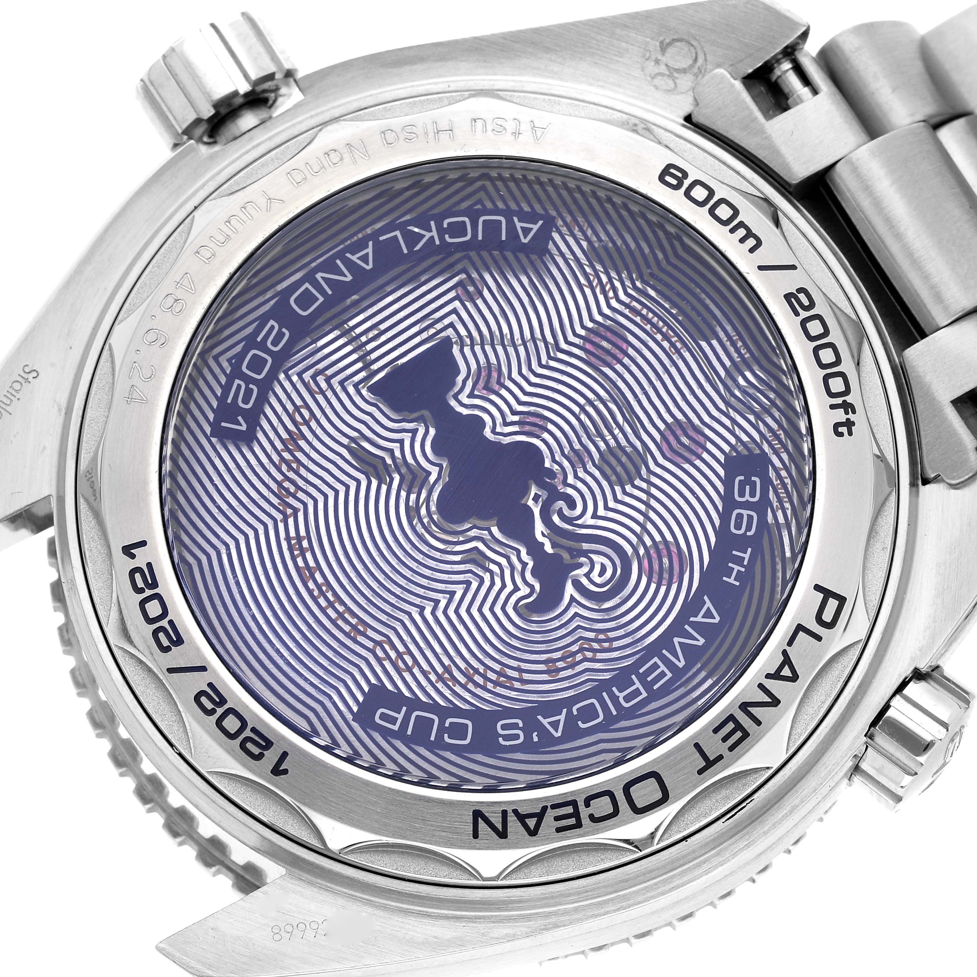 The image shows the back case of the Omega Planet Ocean 215.32.43.21.04.001 Men's Stainless Steel White Dial 215.32.43.21.04.001 Men's Stainless Steel White Dial watch, displaying details and engravings, including "600m/2000ft" and "36th America's Cup."