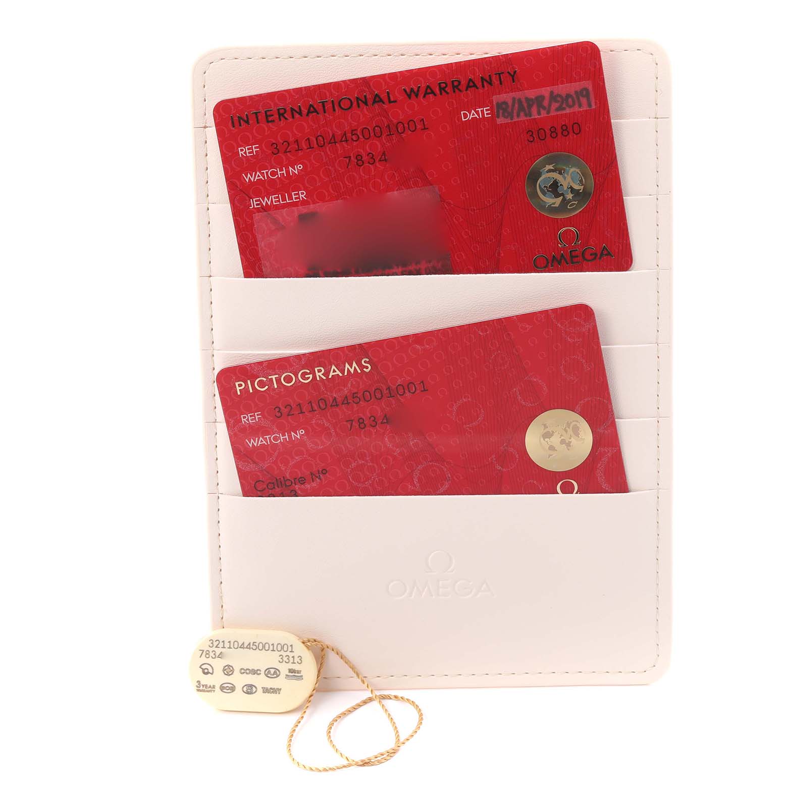 The image displays warranty and pictogram cards in a holder, and a tag for the Omega Speedmaster 321.10.44.50.01.001 Men
s Stainless Steel Black Dial 321.10.44.50.01.001 Men
s Stainless Steel Black Dial Broad Arrow model.