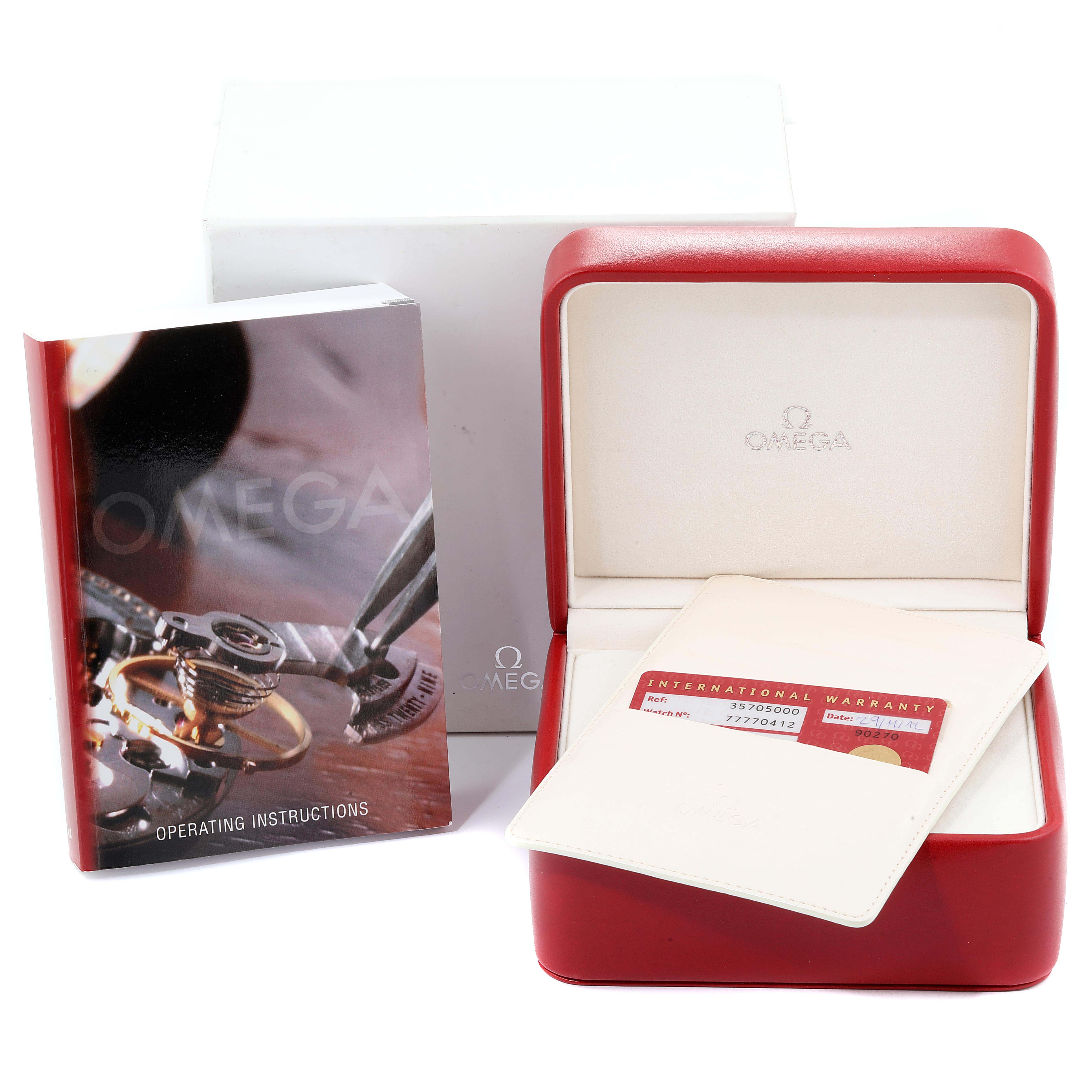 The image shows the Omega Speedmaster 3570.50.00 Men
s Stainless Steel Black Dial 3570.50.00 Men
s Stainless Steel Black Dial watch accessories, including a red watch box, warranty card, and operating instructions manual.