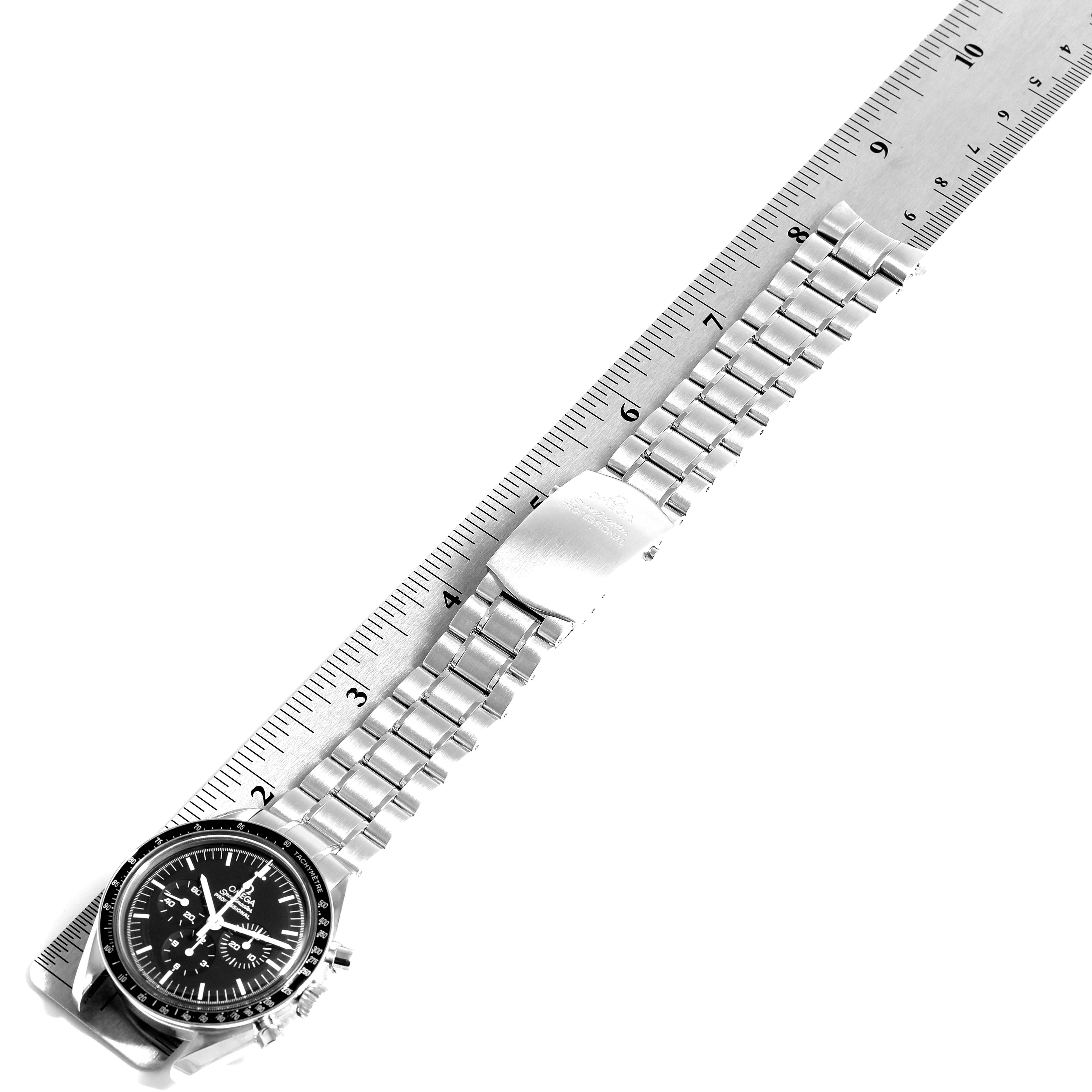 The image shows a top-down view of an Omega Speedmaster 3570.50.00 Men
s Stainless Steel Black Dial 3570.50.00 Men
s Stainless Steel Black Dial watch, including the face, bezel, and metal bracelet with a ruler for scale.