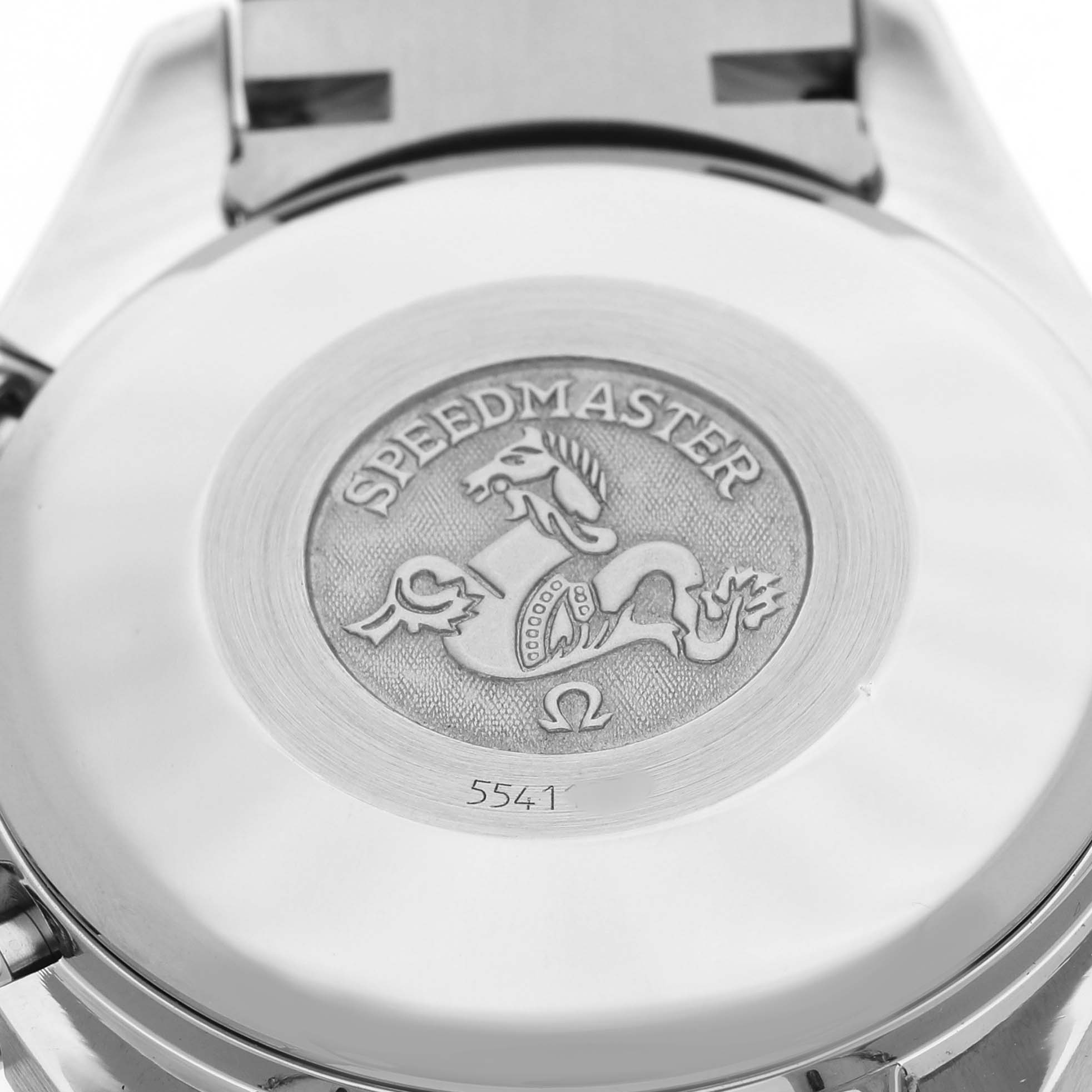 The image shows the engraved case back of an Omega Speedmaster 3813.53.26 Men's Stainless Steel Black Dial watch, displaying its emblem and model information.
