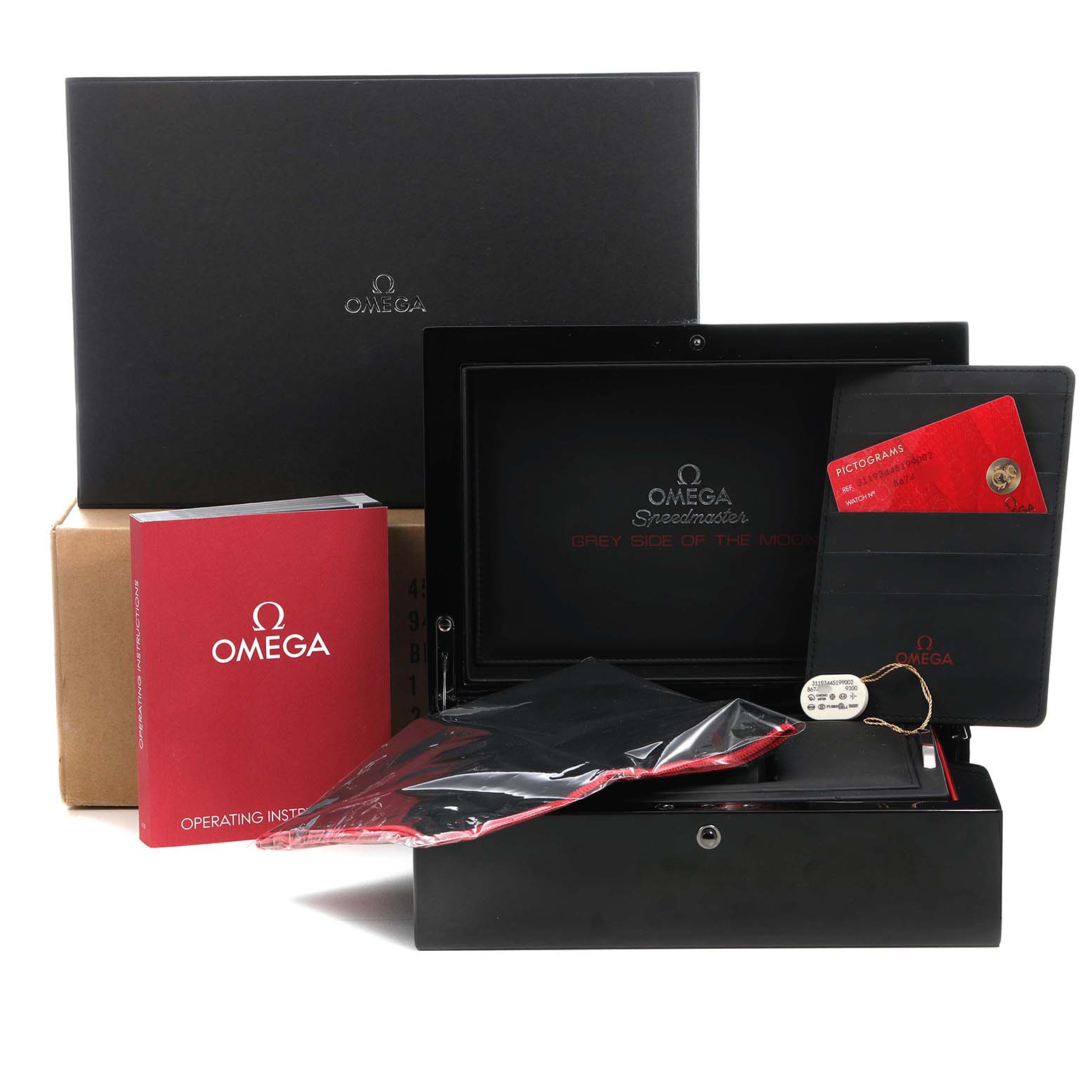 The image shows the packaging and accessories for an Omega Speedmaster 311.93.44.51.99.002 Men's Ceramic Silver Dial, including a black box, operating instructions, and certification cards.