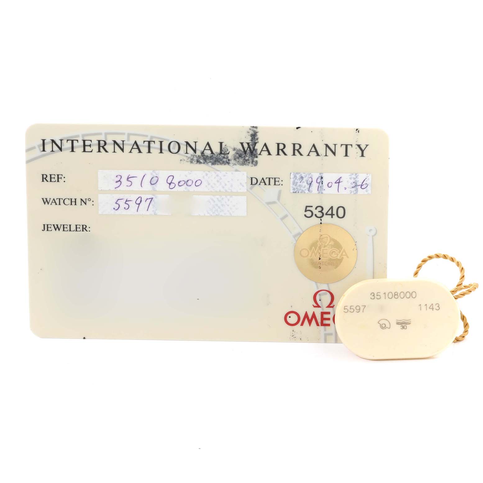 The image shows an Omega Speedmaster 3510.80.00 Men's Stainless Steel Blue Dial 3510.80.00 Men's Stainless Steel Blue Dial International Warranty card and a tag with reference numbers.