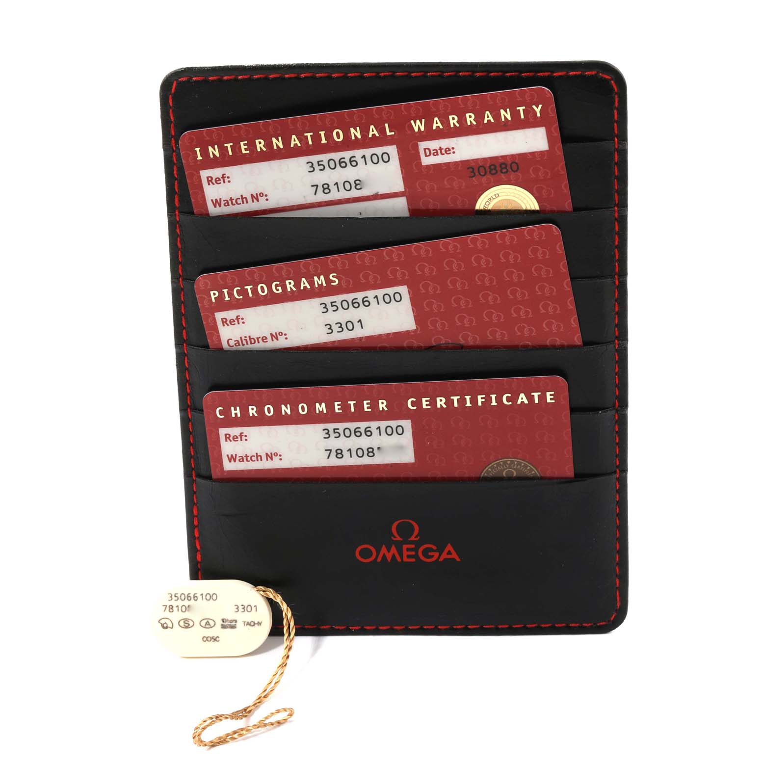 The image shows warranty cards and a certificate holder for the Omega Speedmaster 3506.61.00 Men
s Stainless Steel Red Dial 3506.61.00 Men
s Stainless Steel Red Dial watch, along with a tag.