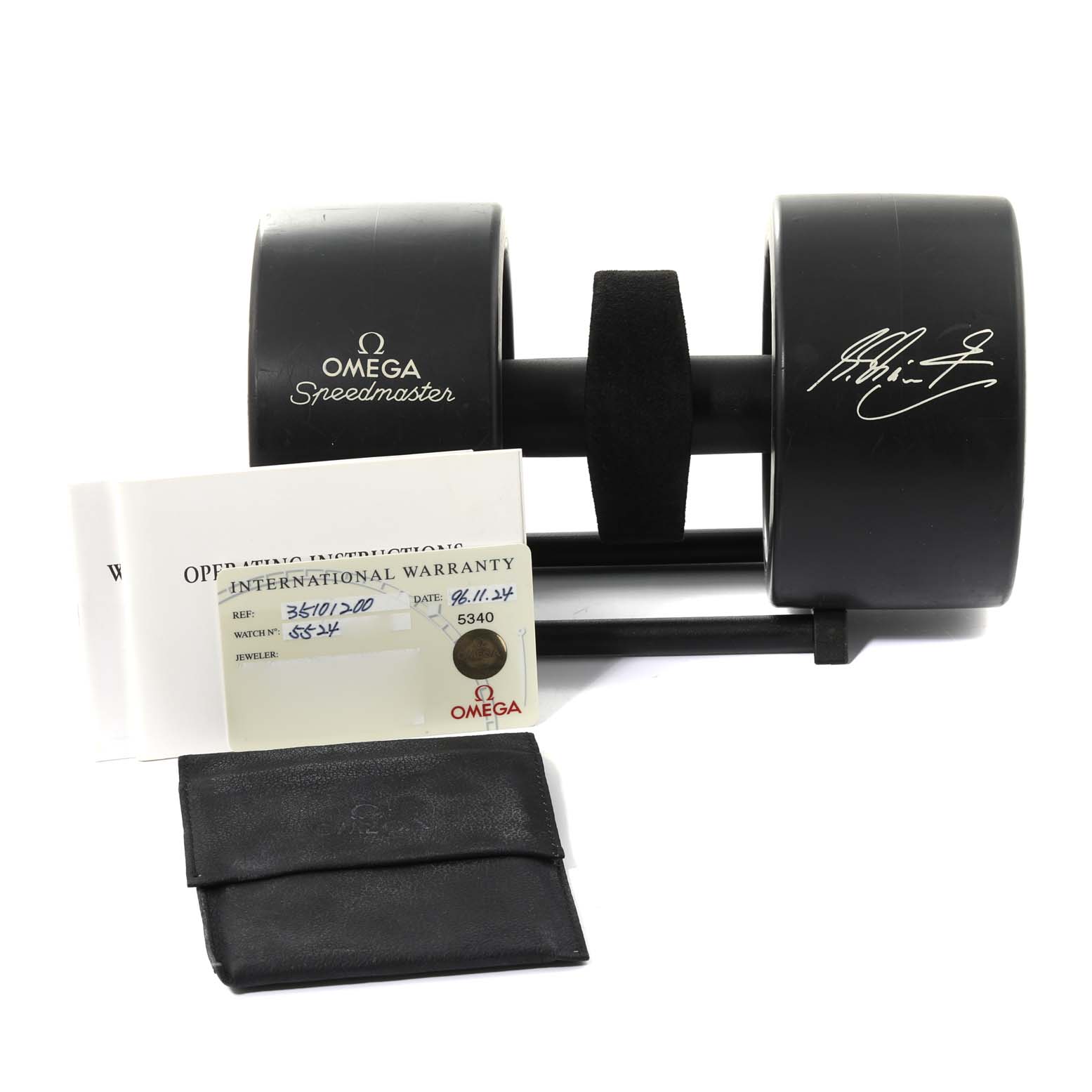 The image shows the packaging and accessories for an Omega Speedmaster 3510.12.00 Men's Stainless Steel Yellow Dial 3510.12.00 Men's Stainless Steel Yellow Dial watch, including a box, warranty card, instruction manual, and a pouch.