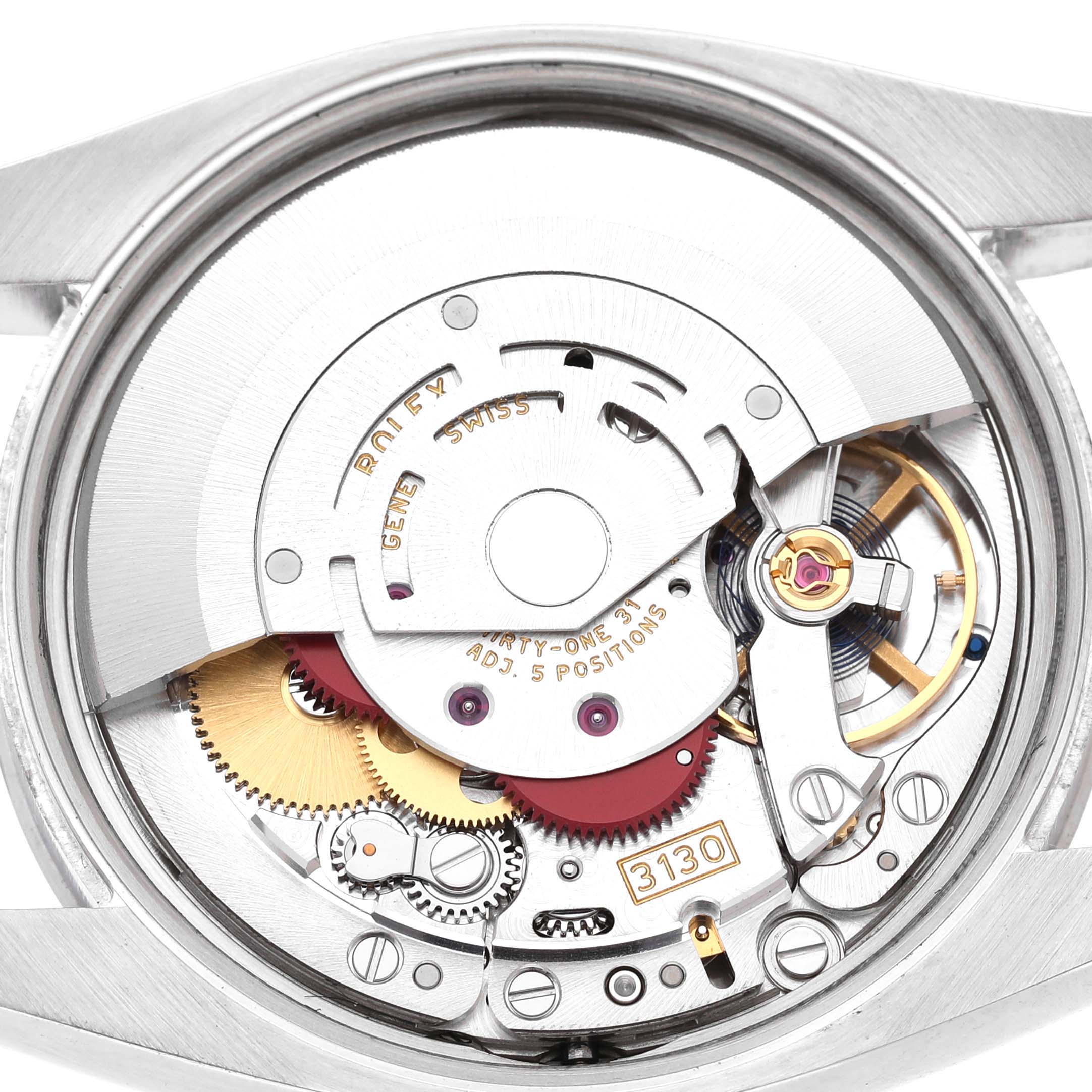 The image shows the internal mechanism of the Rolex Air-King 114200 Men's Stainless Steel Silver Dial watch, focusing on the movement and intricate components.