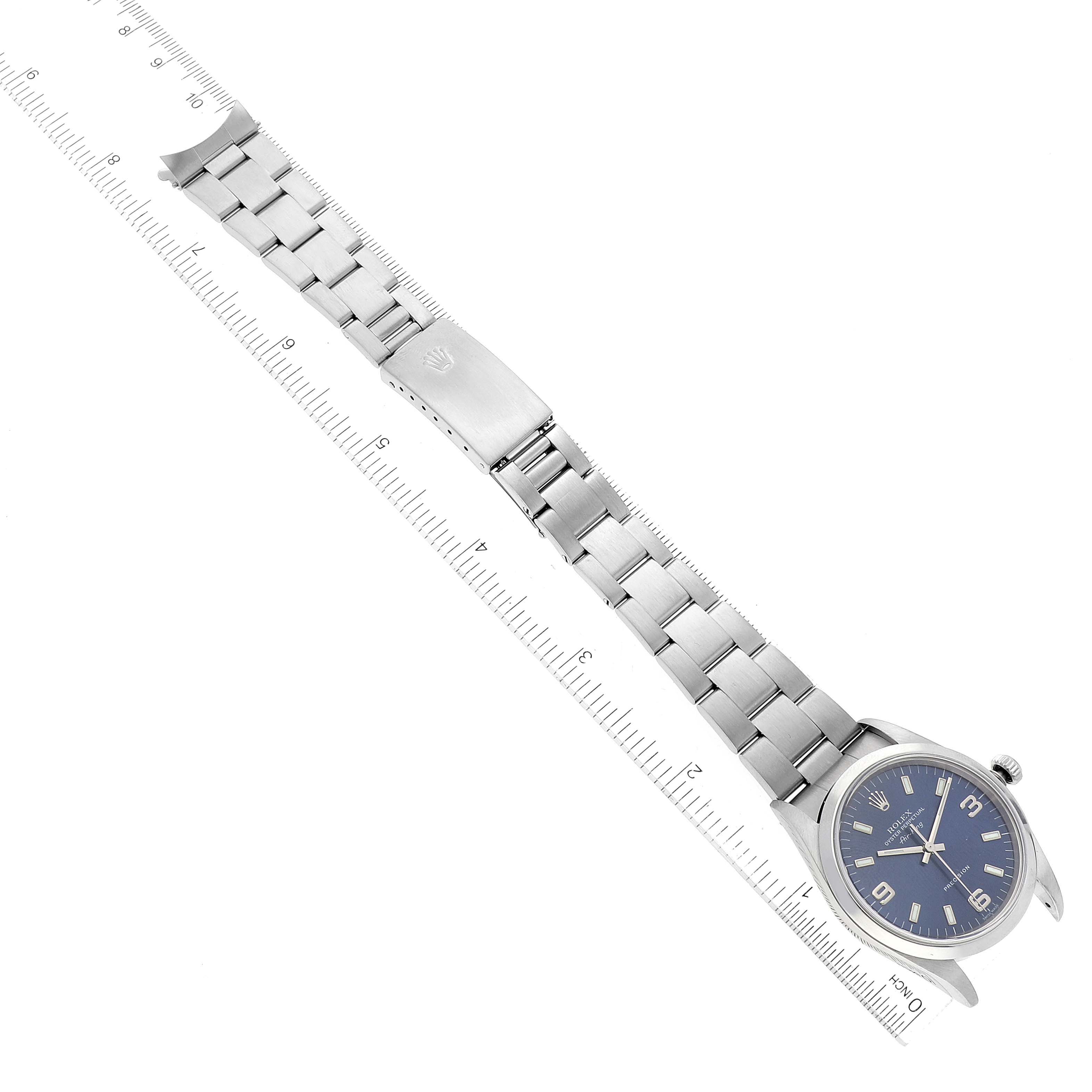 The Rolex Air-King 14000 Men's Stainless Steel Blue Dial 14000 Men's Stainless Steel Blue Dial watch is shown from the top view, displaying the full bracelet and face along with a measuring ruler beside it.