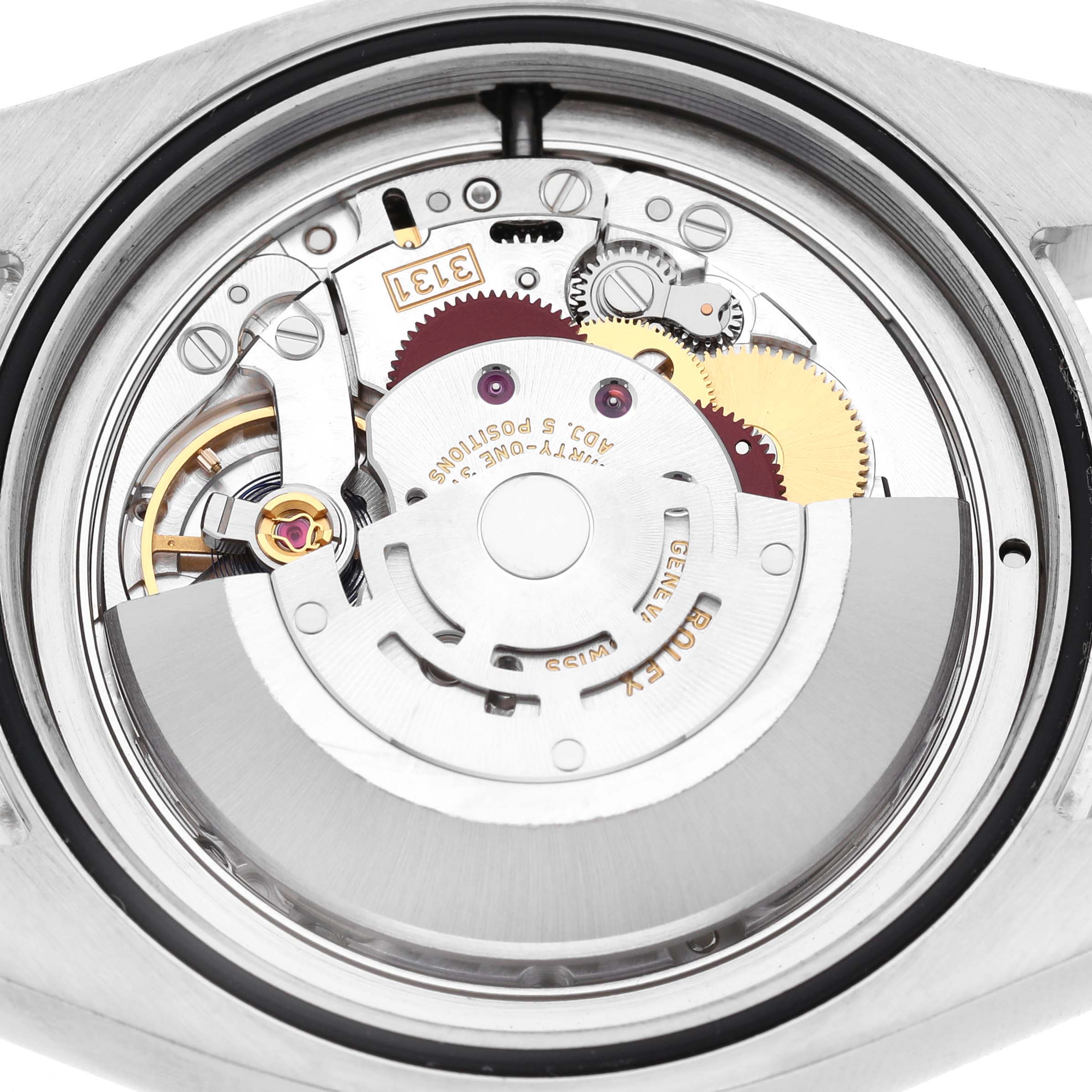 The image shows the Rolex Air-King M116900-0001 Men's Stainless Steel Black Dial watch movement from the back, highlighting its intricate gears and rotor.