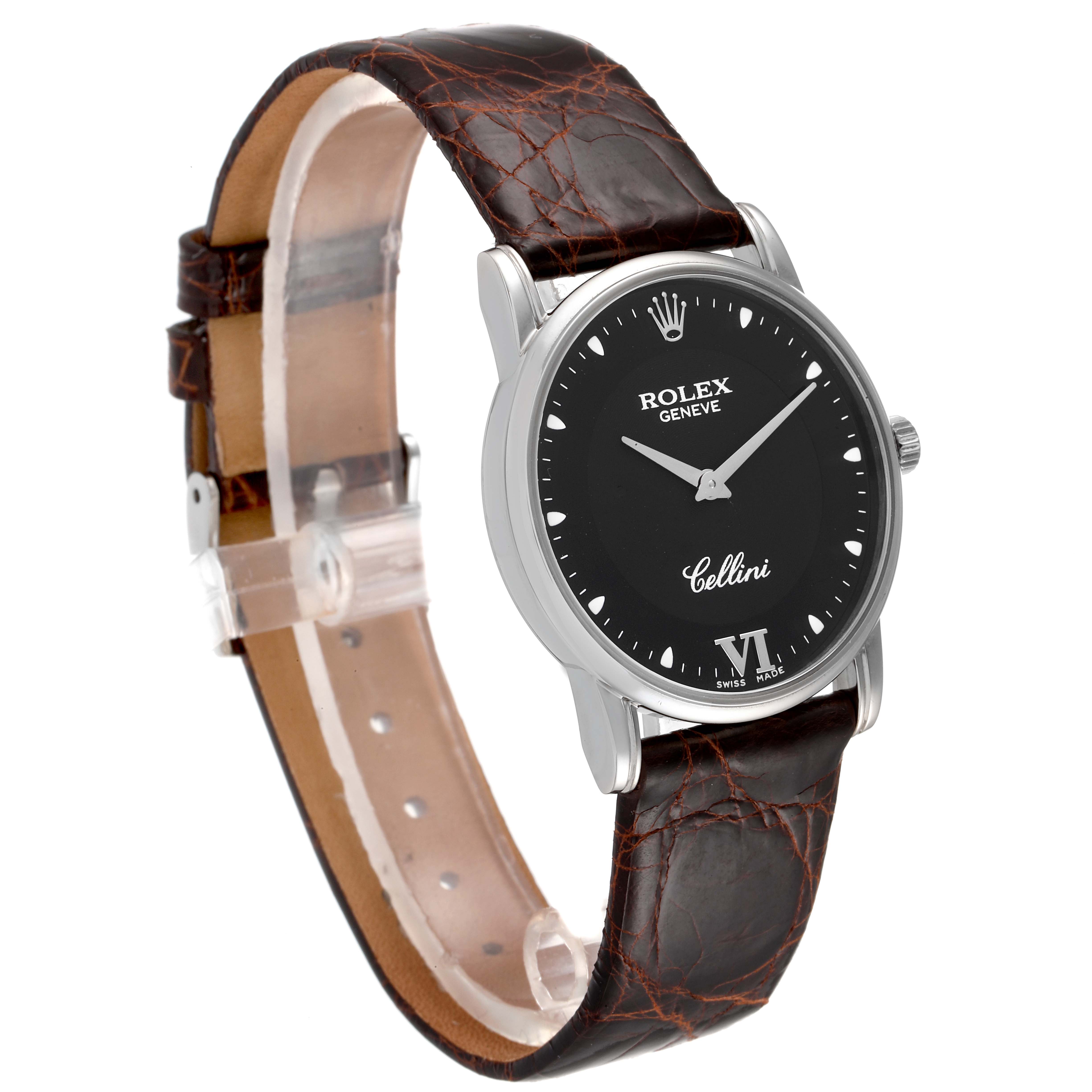 The Rolex Cellini 5116 Men's White Gold Black Dial 5116 Men's White Gold Black Dial watch is shown at a slight angle, displaying its black dial, stainless steel case, and brown leather strap.