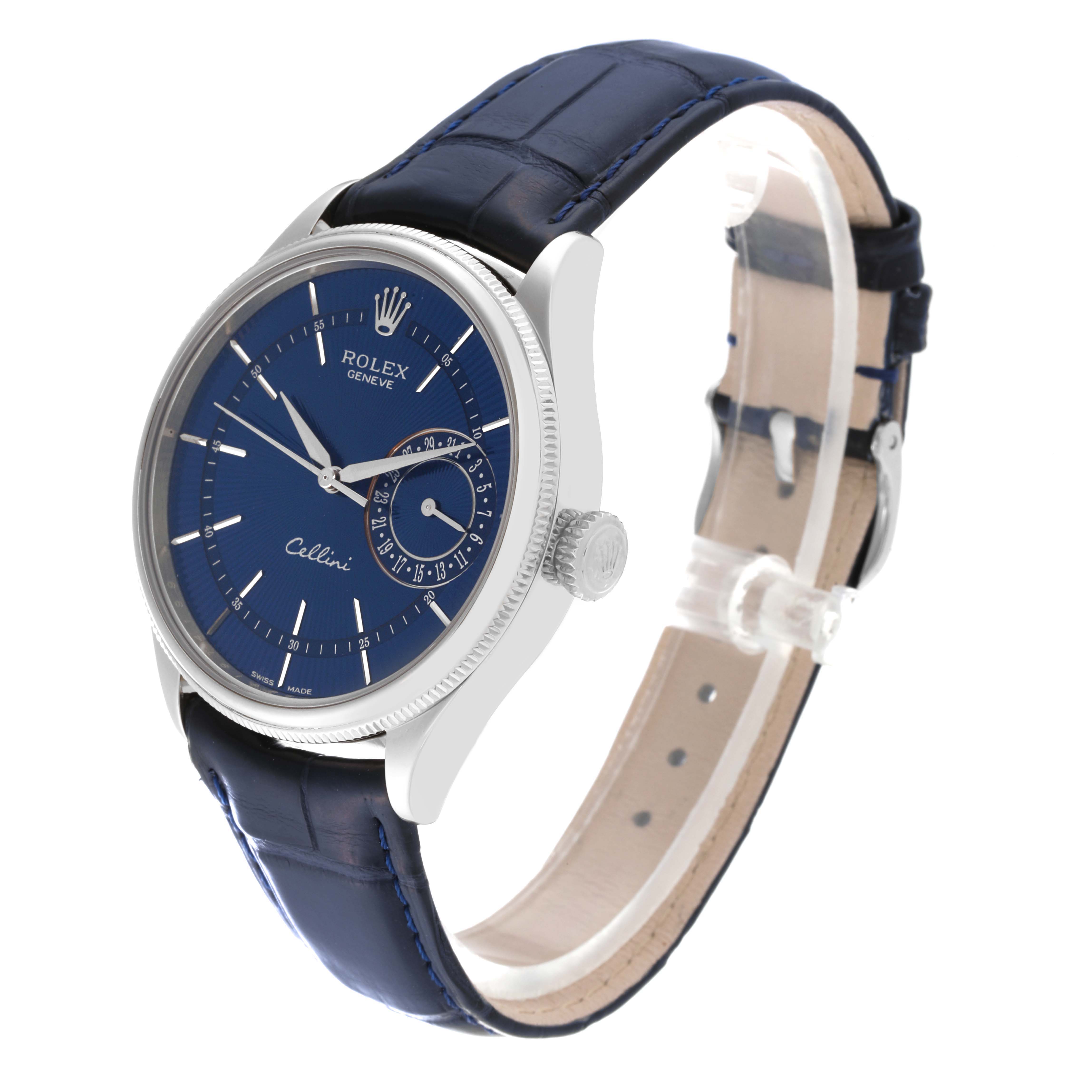 The image shows a Rolex Cellini 50519 Men
s White Gold Blue Dial 50519 Men
s White Gold Blue Dial watch at an angle displaying its blue dial, case, crown, and blue leather strap.