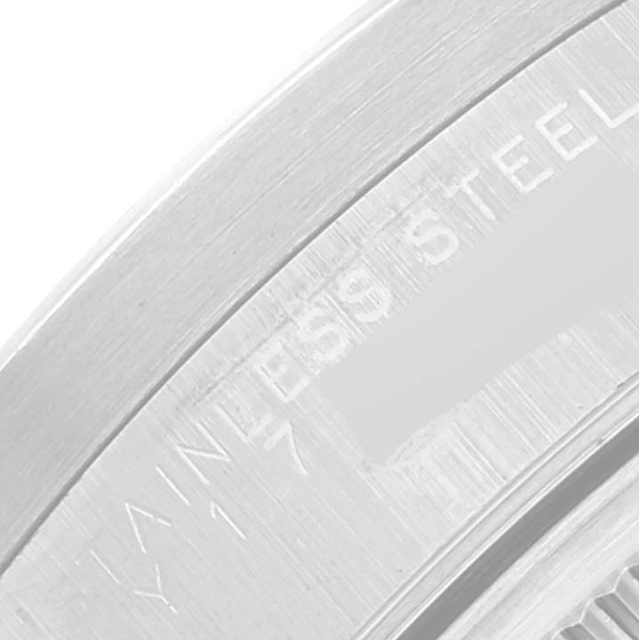 The close-up image shows a part of the watch case of a Rolex Date 15210 Men's Stainless Steel Black Dial 15210 Men's Stainless Steel Black Dial model, featuring "STAINLESS STEEL" engraving.