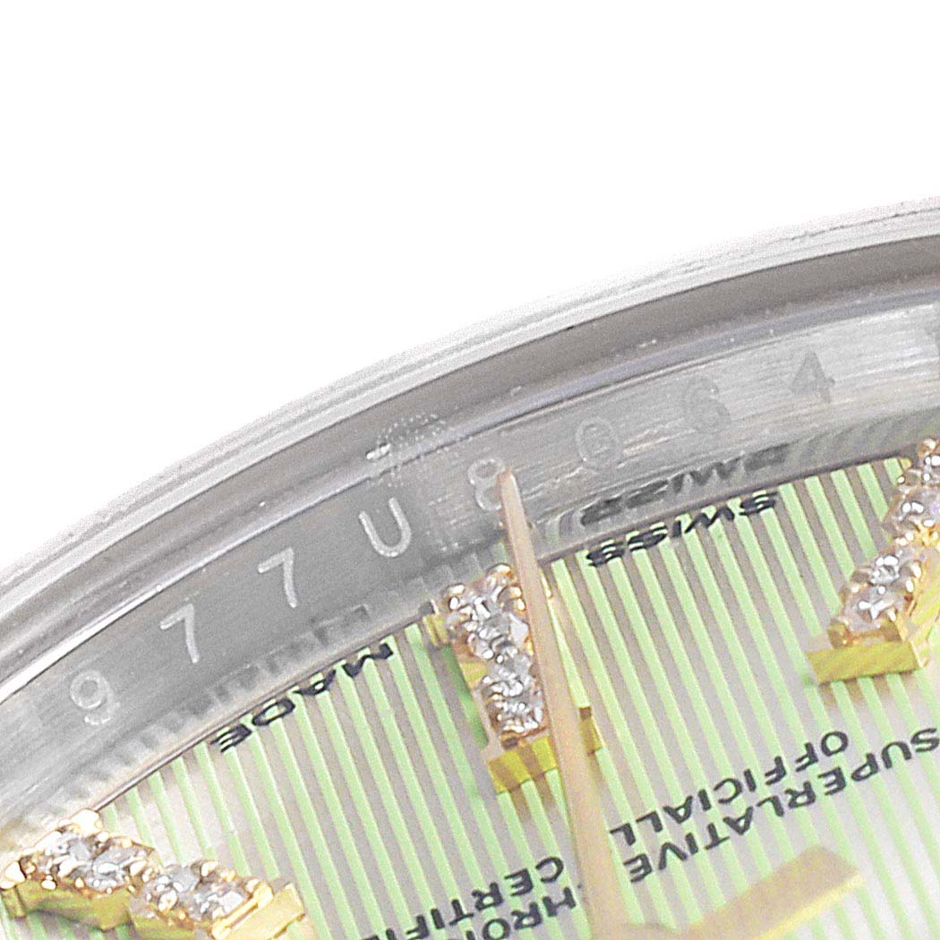 The image shows a close-up of a Rolex Datejust 279173 Women's Steel and Gold (two tone) Green Dial 279173 Women's Steel and Gold (two tone) Green Dial watch's dial, markers, hands, and part of the engraved serial number on the inner bezel.