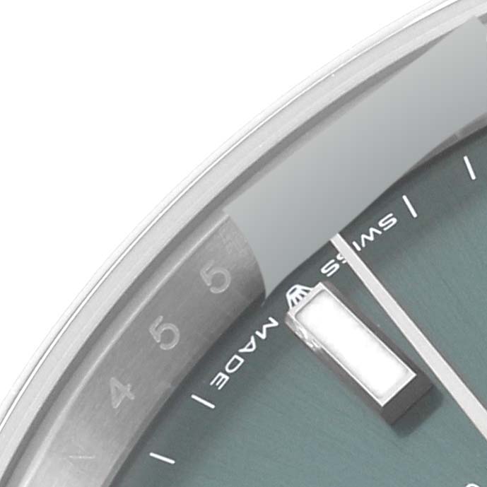 This is a close-up of the dial and bezel of a Rolex Datejust 41 126300 Men's Stainless Steel Green Dial 126300 Men's Stainless Steel Green Dial, featuring the "Swiss Made" text and a part of the hour markers.