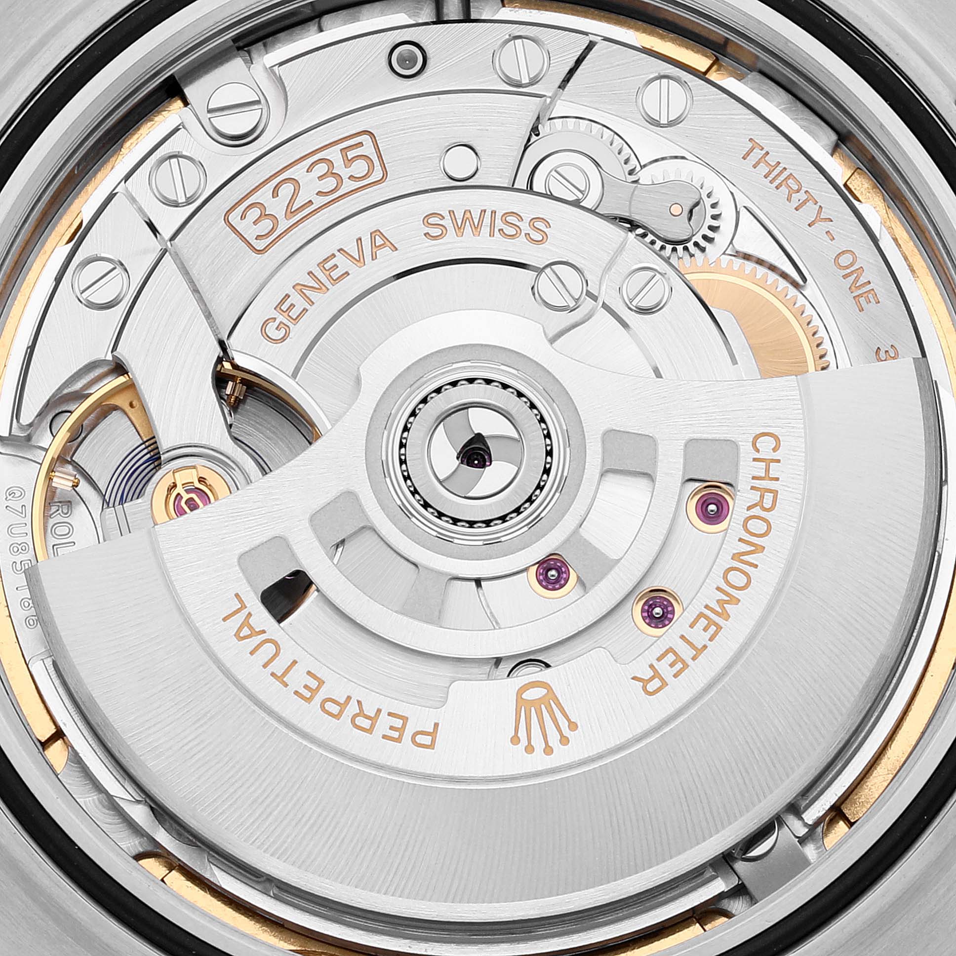 The image shows a close-up view of the Rolex Datejust 41 126300 Men's Stainless Steel Green Dial 126300 Men's Stainless Steel Green Dial's movement, highlighting its intricate internal components like the rotor and gears.