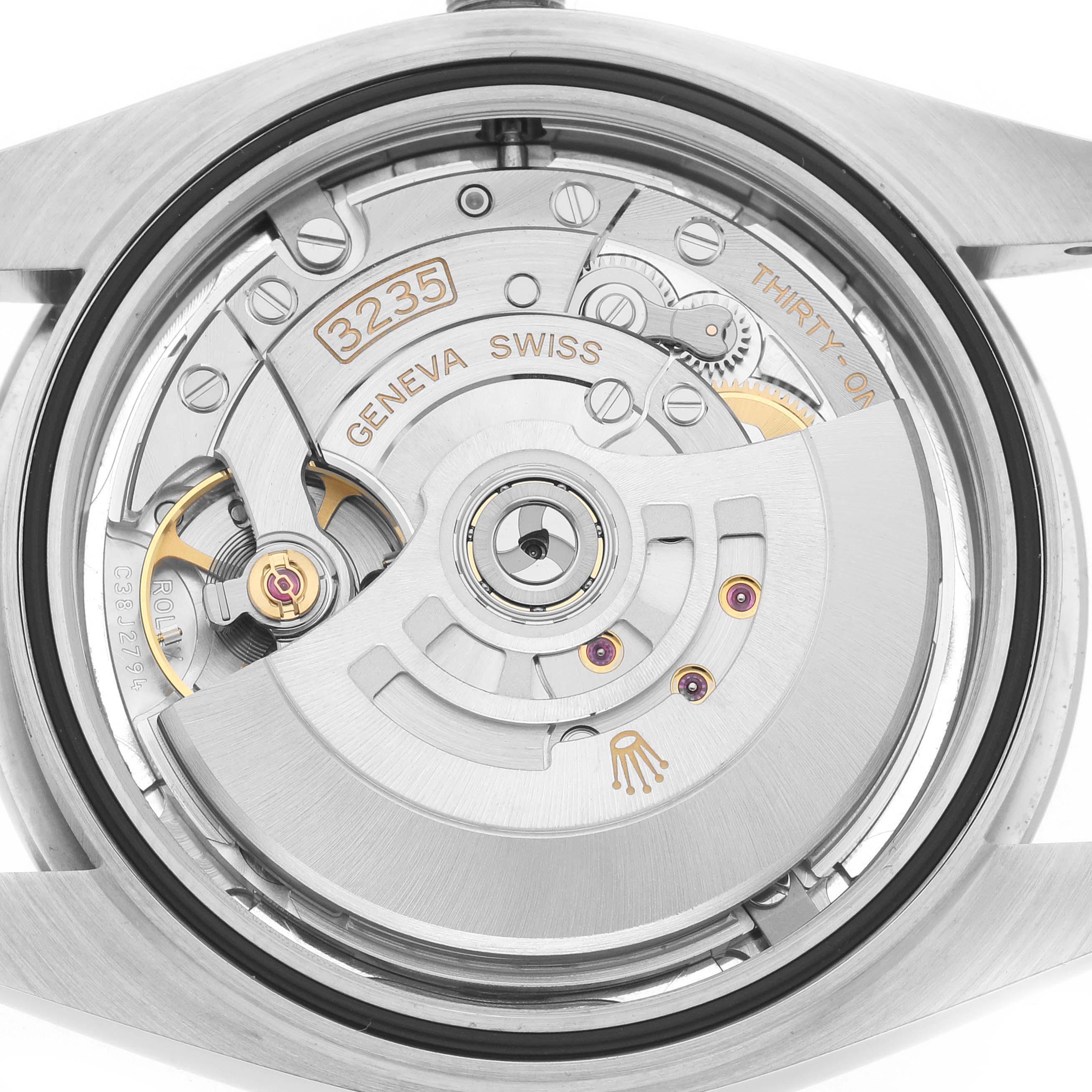 The image shows the back view of a Rolex Datejust 126300 Men
s Stainless Steel Silver Dial 126300 Men
s Stainless Steel Silver Dial watch, highlighting its intricate movement and rotor.