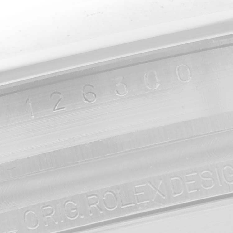 The image shows a close-up of the case engraving on a Rolex Datejust 126300 Men
s Stainless Steel Silver Dial 126300 Men
s Stainless Steel Silver Dial, highlighting the model number and brand engraving.
