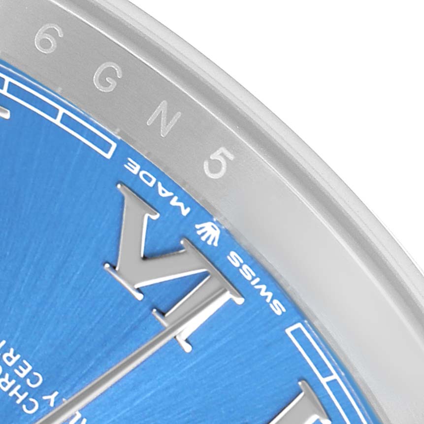 The image shows a close-up of the bezel and part of the blue dial with Roman numerals on a Rolex Datejust 41 126300 Men's Stainless Steel Blue Dial.
