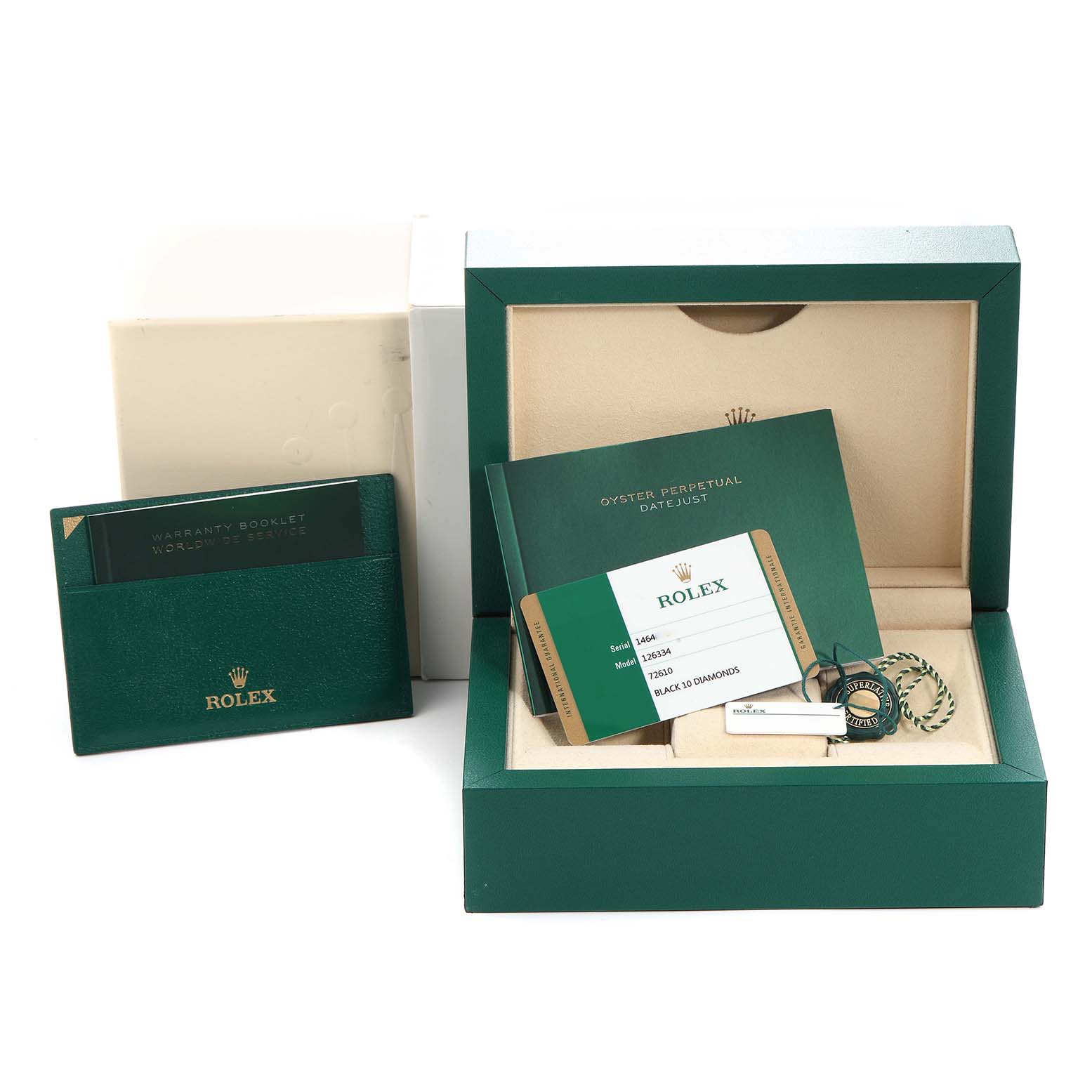 The image shows the packaging and accessories of a Rolex Datejust, including a box, warranty booklet, catalog, and tags.