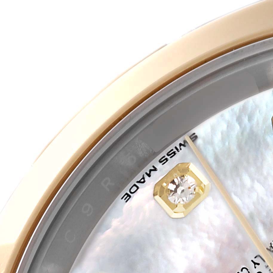 This close-up shows the bezel, part of the dial, a diamond marker, and hands of the Rolex Datejust 41 126303 Men's Steel and Gold (two tone) Mother of Pearl Dial 126303 Men's Steel and Gold (two tone) Mother of Pearl Dial watch.