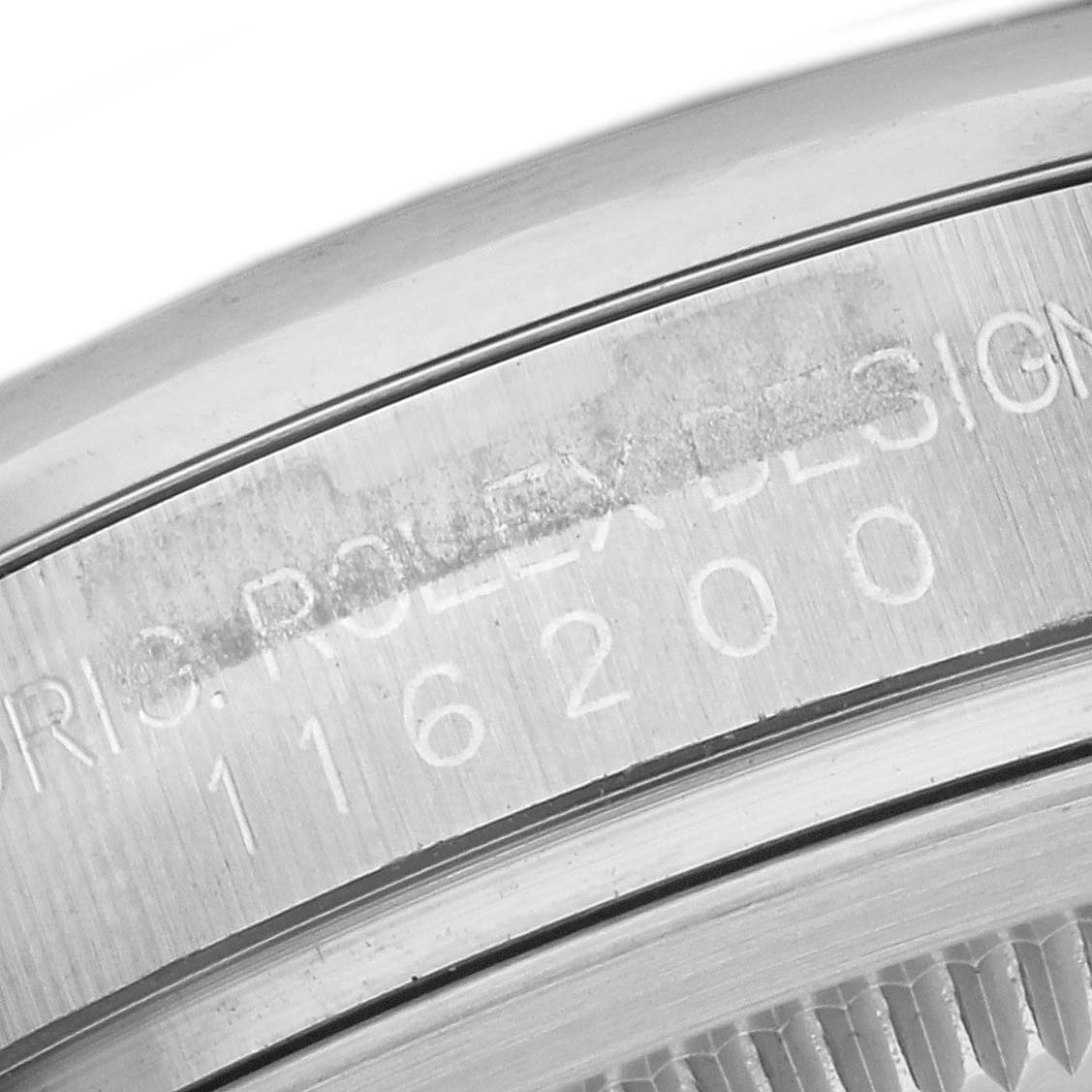 This image shows a close-up of the Rolex Datejust 116200 Men
s Stainless Steel Black Dial 116200 Men
s Stainless Steel Black Dial model
s serial number engraving on the case.