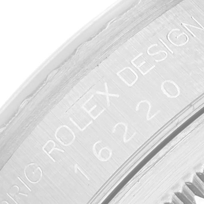 This close-up shows the engraved serial number and "ROLEX DESIGN" text on the Datejust model by Rolex.