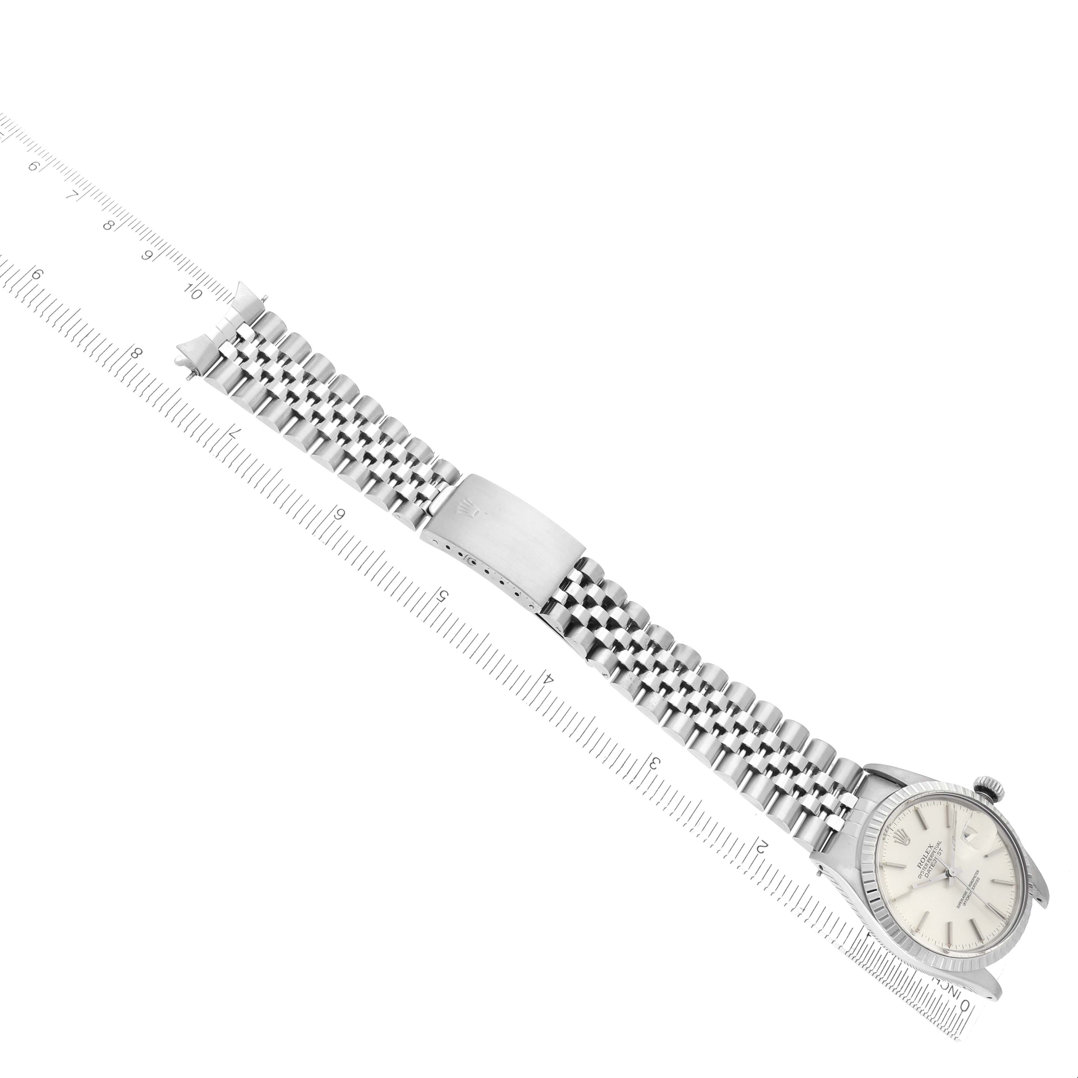 The Rolex Datejust 16030 Men
s Stainless Steel Silver Dial 16030 Men
s Stainless Steel Silver Dial is shown from an elevated angle, displaying the full bracelet and the watch face partially, with a ruler beside it.