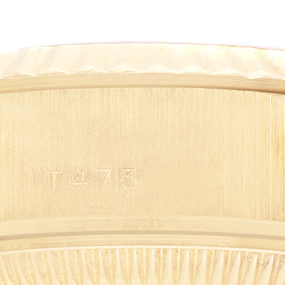 This image shows a close-up of the side of the casing and bezel of a Rolex President 69178 Women's Yellow Gold Champagne Dial 69178 Women's Yellow Gold Champagne Dial watch, focusing on the serial number area.