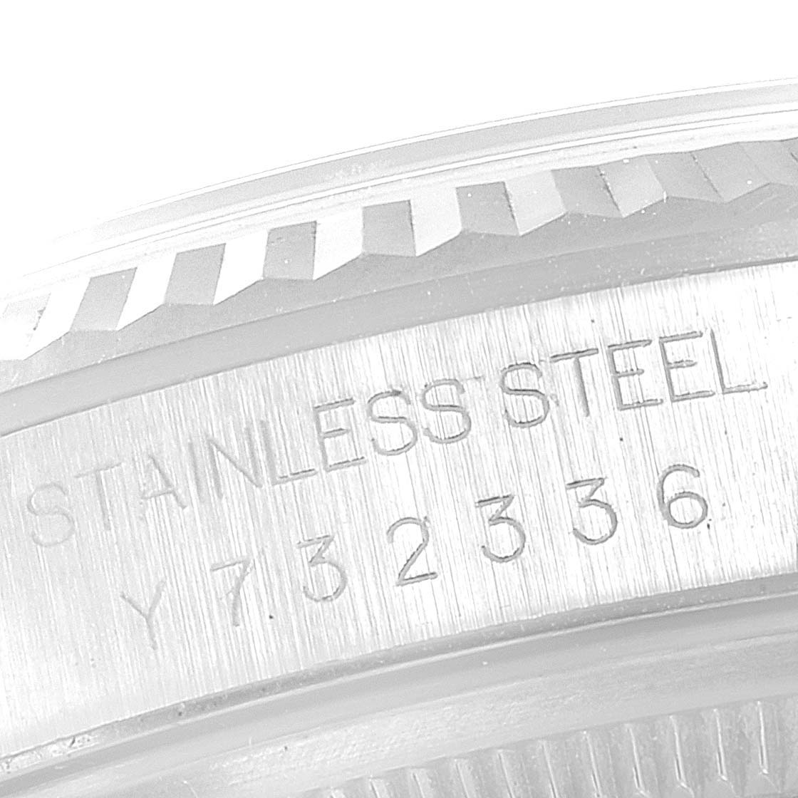 The image shows the engraved stainless steel side of the bezel and case of a Rolex Datejust 16234 Men's Stainless Steel Silver Dial 16234 Men's Stainless Steel Silver Dial watch.