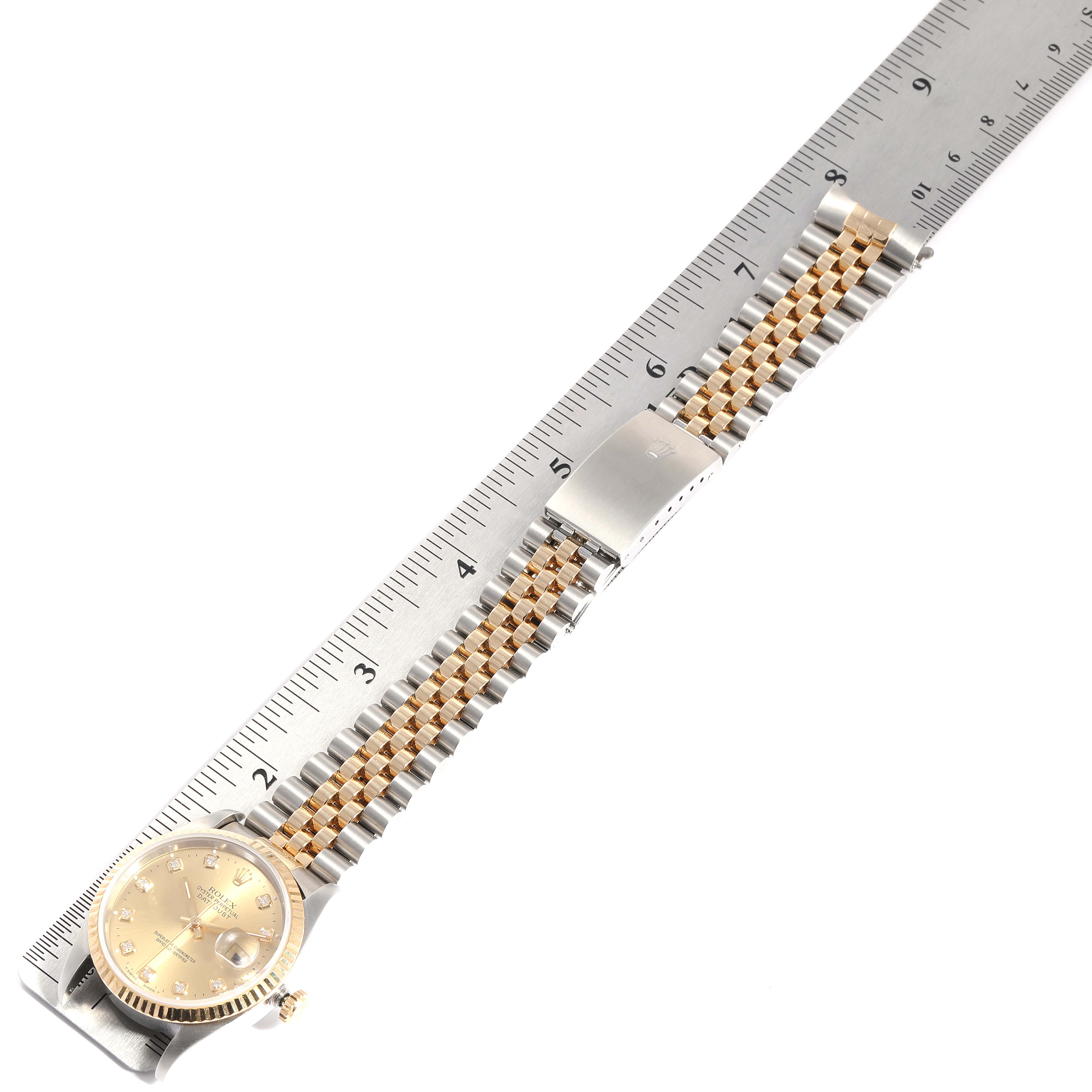 This image shows a Rolex Datejust 16233 Men's Steel and Gold (two tone) Champagne Dial 16233 Men's Steel and Gold (two tone) Champagne Dial watch laid flat with its bracelet measured against a ruler.
