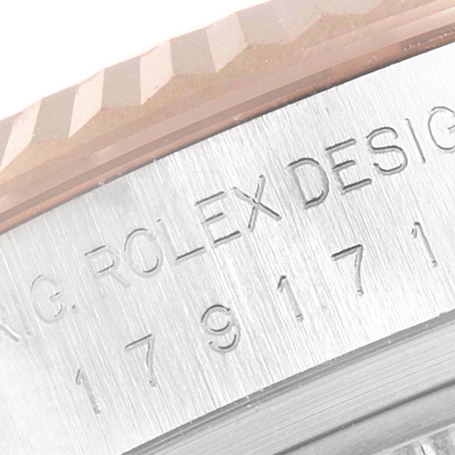 The image shows a close-up of the Rolex Datejust 179171 Women's Stainless Steel Mother of Pearl Dial's fluted bezel and engraved case side.