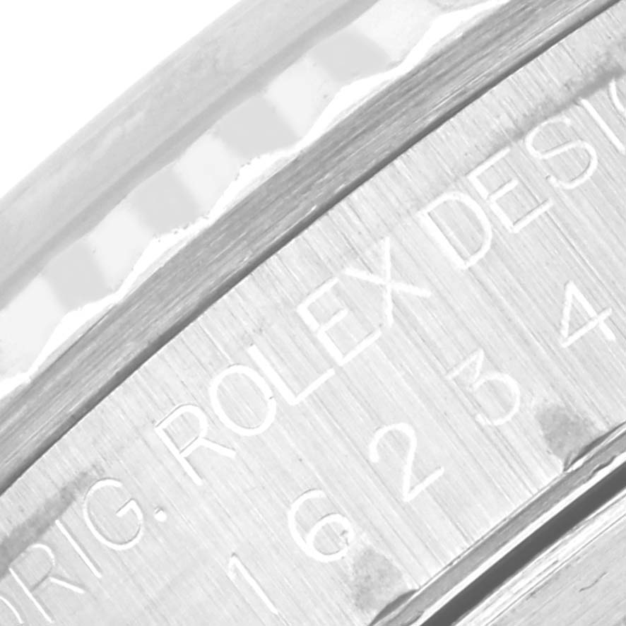 The image shows a close-up of the case side and part of the bezel of a Rolex Datejust 16234 Men's Stainless Steel Silver Dial 16234 Men's Stainless Steel Silver Dial watch, with engraved text visible.