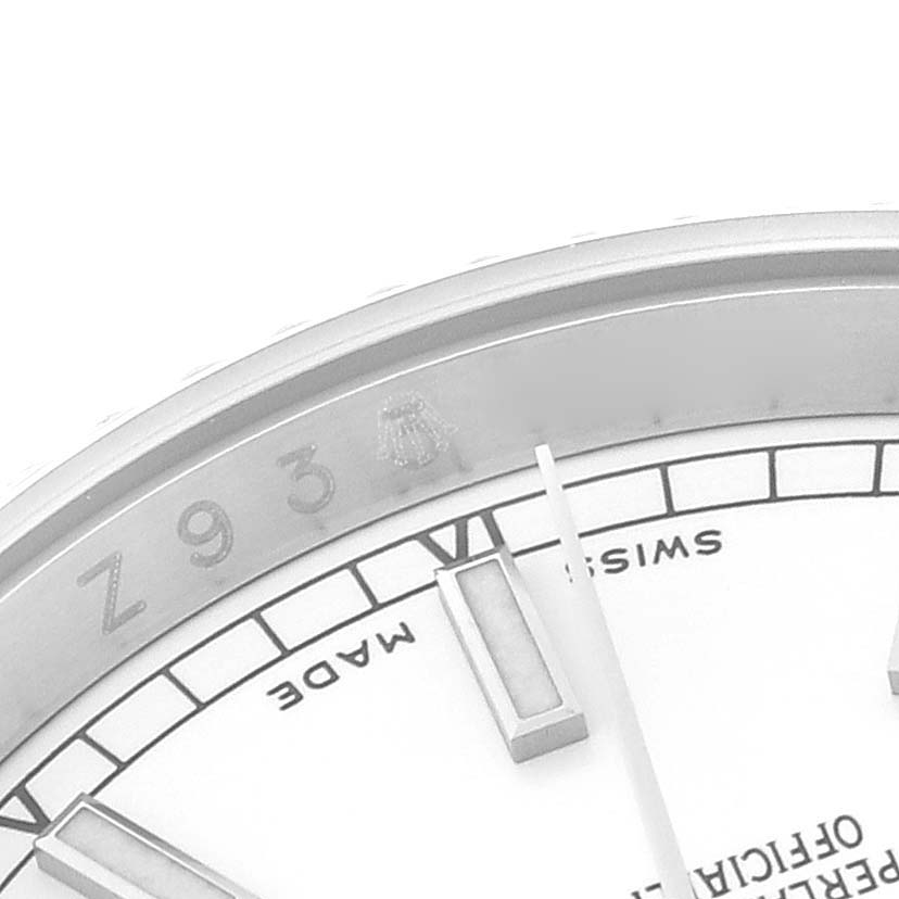 Close-up of the Rolex Datejust 116234 Men's Stainless Steel White Dial 116234 Men's Stainless Steel White Dial watch, showing part of the dial, indices, and the rim with engravings.