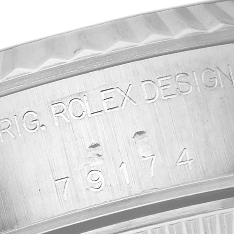The image shows a close-up of the engravings on the case band of a Rolex Datejust 79174 Women's Stainless Steel Mother of Pearl Dial 79174 Women's Stainless Steel Mother of Pearl Dial watch.