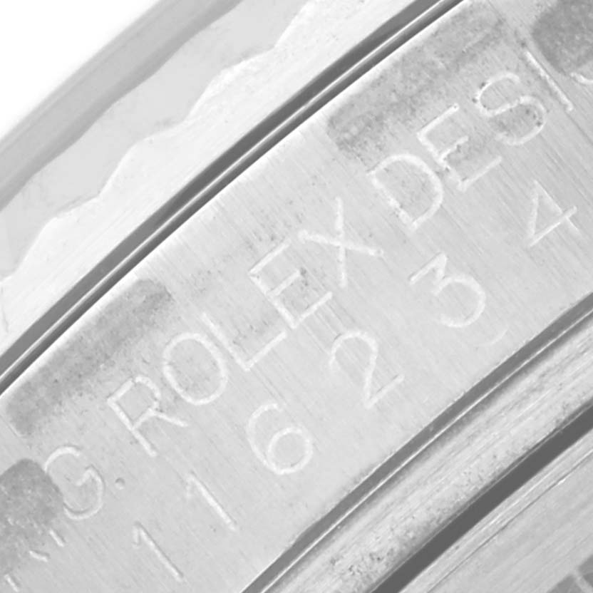 This image shows an angled close-up of the engraving on the case side of a Rolex Datejust 116234 Men's Stainless Steel White Dial 116234 Men's Stainless Steel White Dial watch.