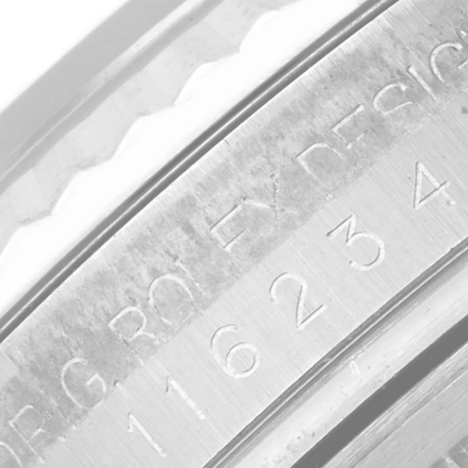 This close-up angle shows part of the case and the serial/part number engraving on a Rolex Datejust 116234 Men's Stainless Steel Silver Dial 116234 Men's Stainless Steel Silver Dial watch.
