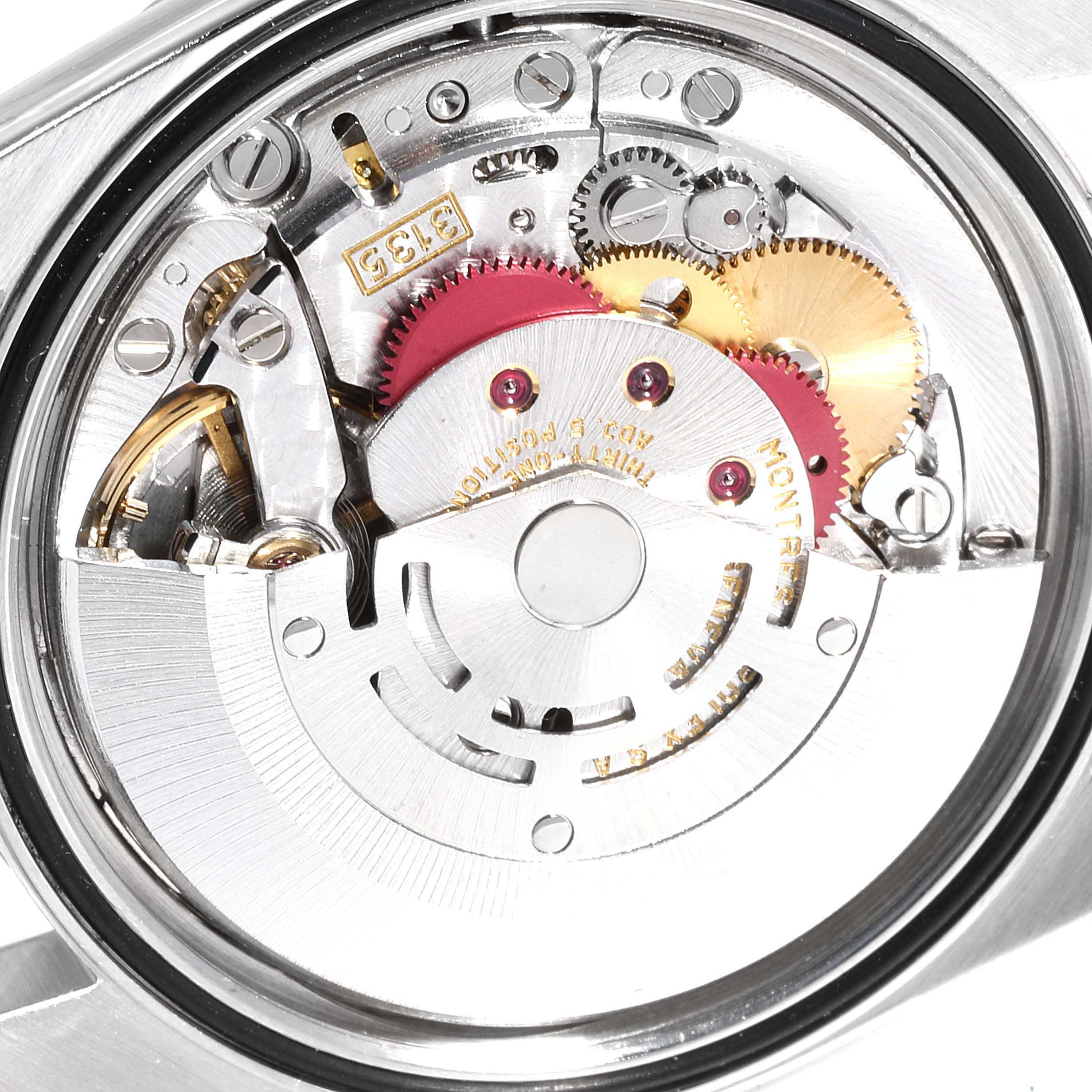 This image shows a close-up view of the movement mechanism of a Rolex Datejust 16233 Men
s Steel and Gold (two tone) Black Dial 16233 Men
s Steel and Gold (two tone) Black Dial watch, highlighting its intricate gears and components.