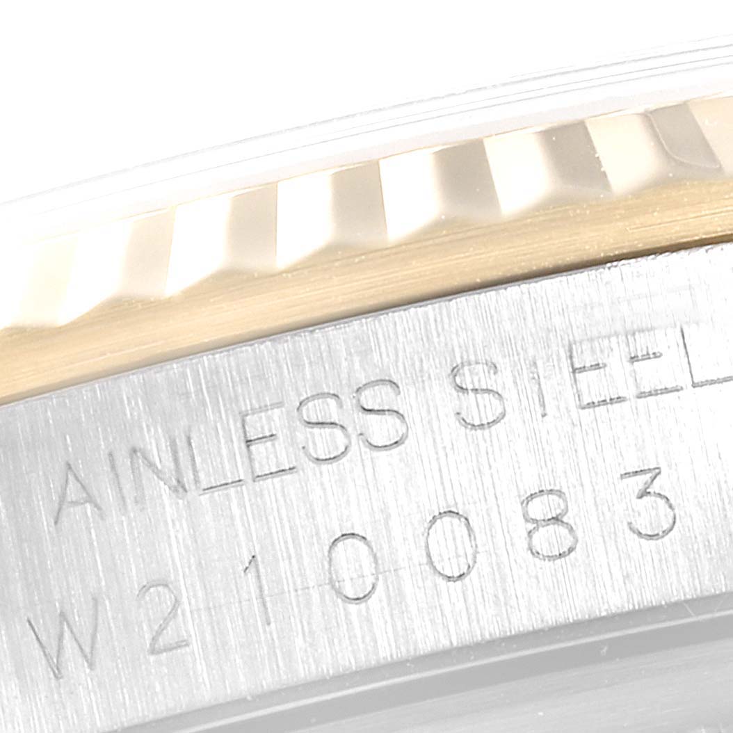 The image shows a close-up of the fluted bezel and engraved serial number on the case of a Rolex Datejust 16233 Men
s Steel and Gold (two tone) Black Dial 16233 Men
s Steel and Gold (two tone) Black Dial watch.