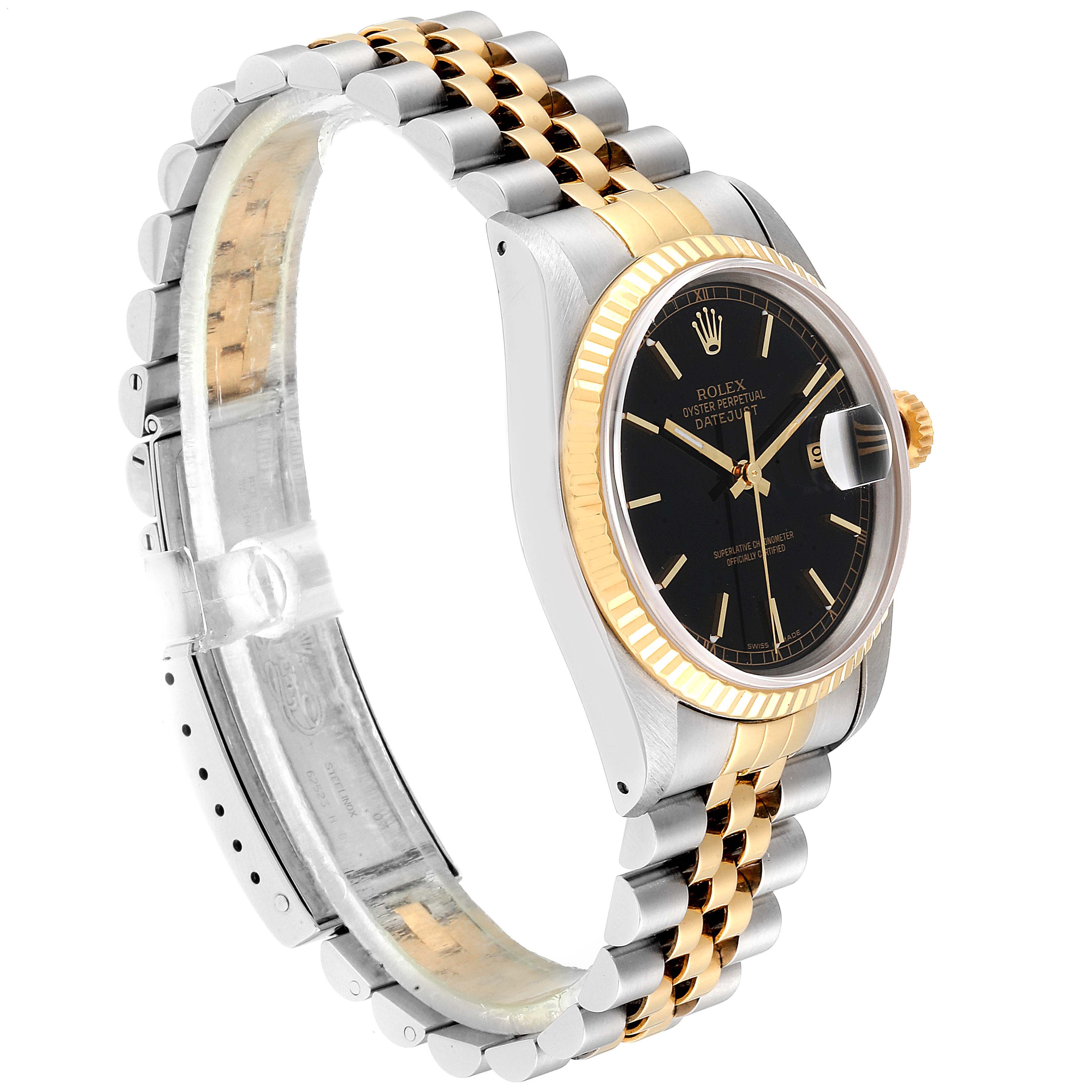 This Rolex Datejust 16233 Men's Steel and Gold (two tone) Black Dial 16233 Men's Steel and Gold (two tone) Black Dial watch is shown at an angle showcasing its black dial, Jubilee bracelet, and fluted bezel.