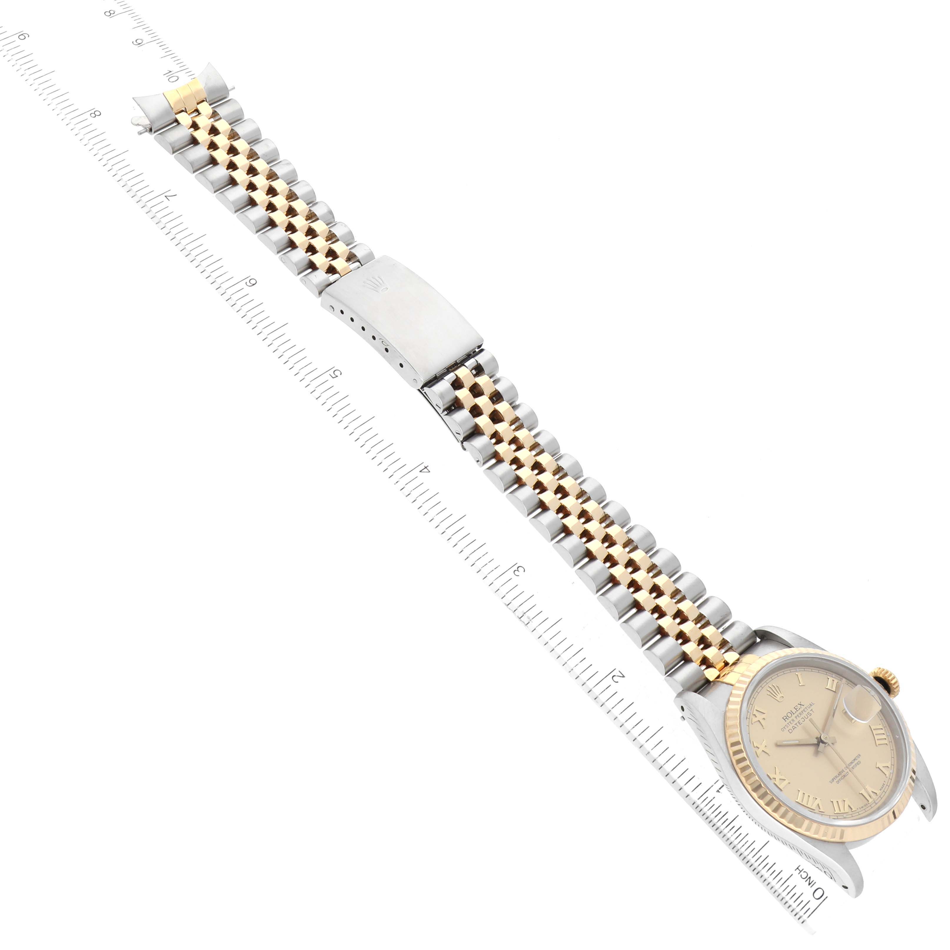 This image shows a Rolex Datejust 16233 Men's Steel and Gold (two tone) Champagne Dial 16233 Men's Steel and Gold (two tone) Champagne Dial watch laid flat, displaying its dial, case, bracelet, and clasp, with a ruler beside it.