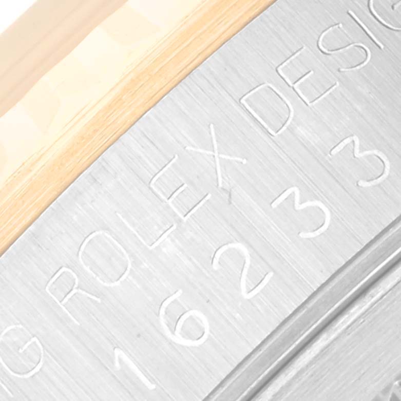 The image shows an angled close-up of the case back of a Rolex Datejust 16233 Men's Steel and Gold (two tone) Champagne Dial 16233 Men's Steel and Gold (two tone) Champagne Dial watch, highlighting the engraved model number and part of the bezel.